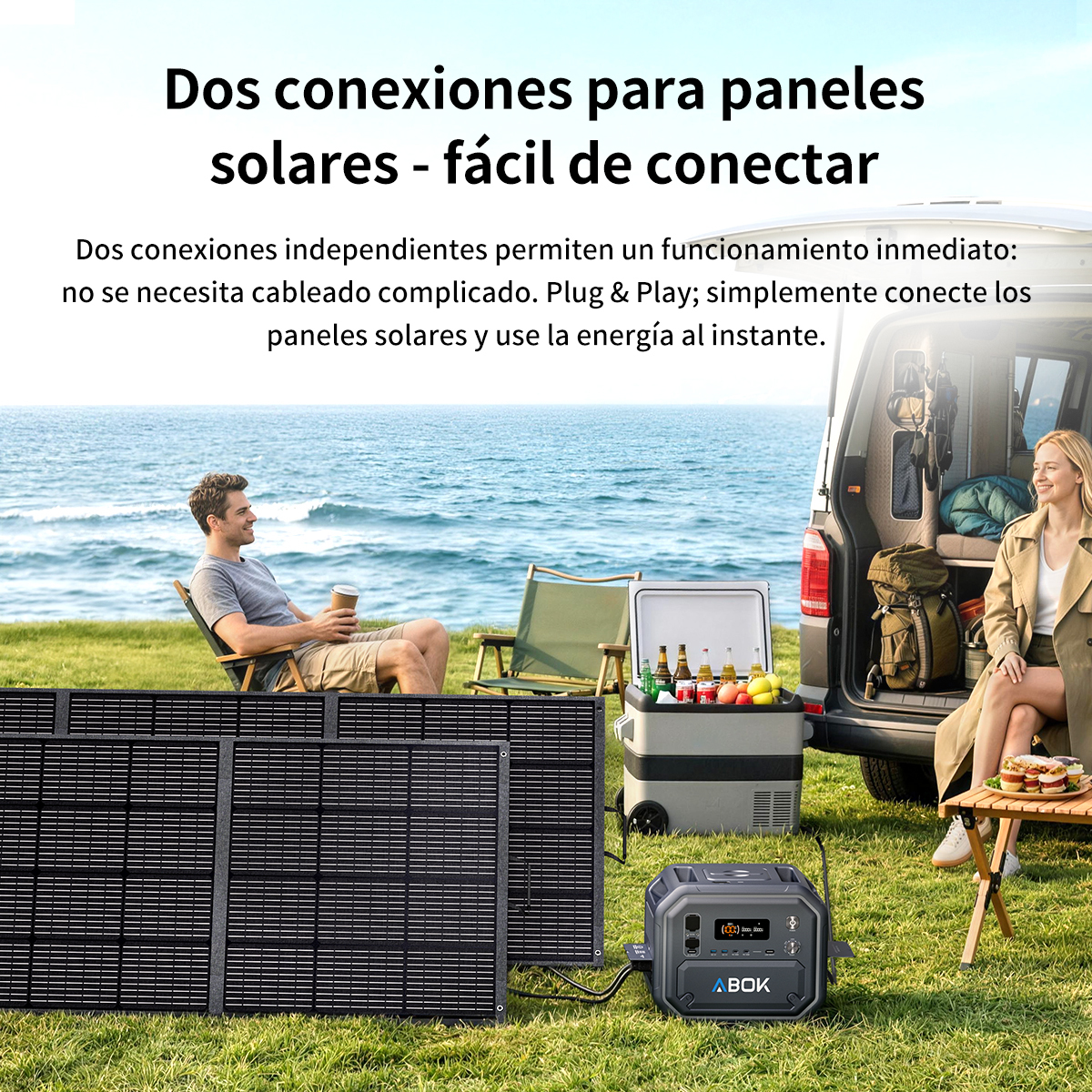 Dos hombres y una mujer acampan junto al mar con paneles solares y nevera.