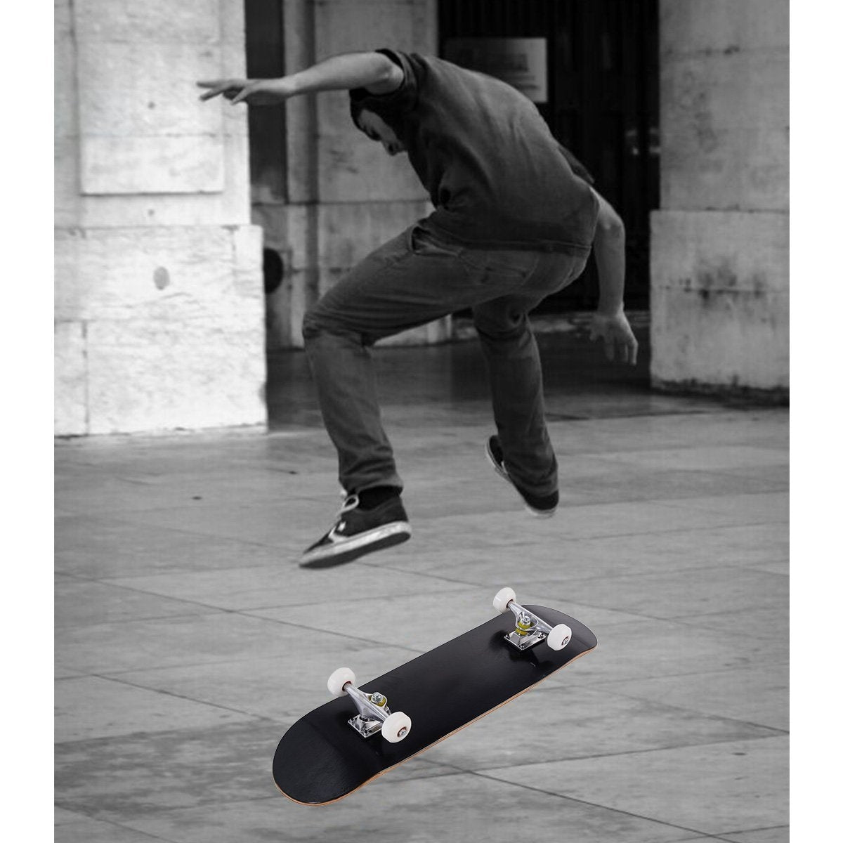 A skateboarder in the air above a black skateboard.