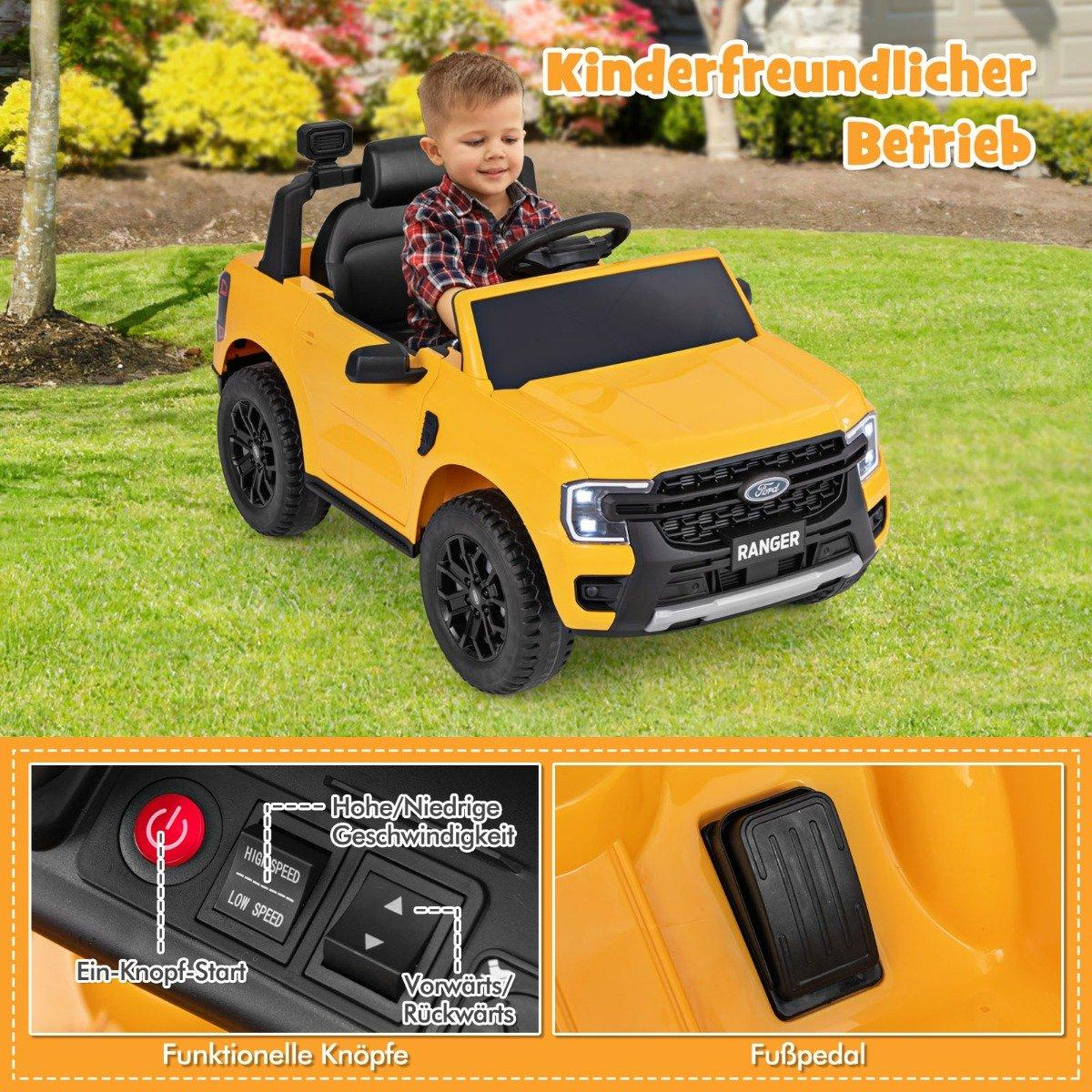A young boy drives a yellow Ford Ranger toy car outdoors.