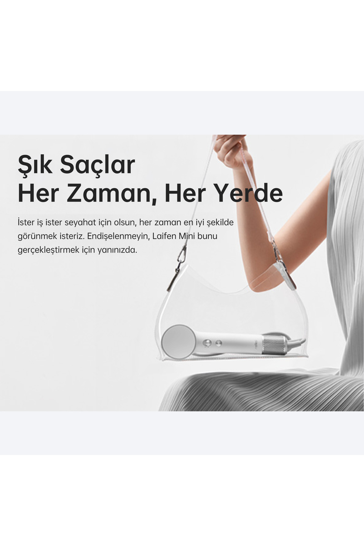 A white hairdryer in a clear bag, held by a person.