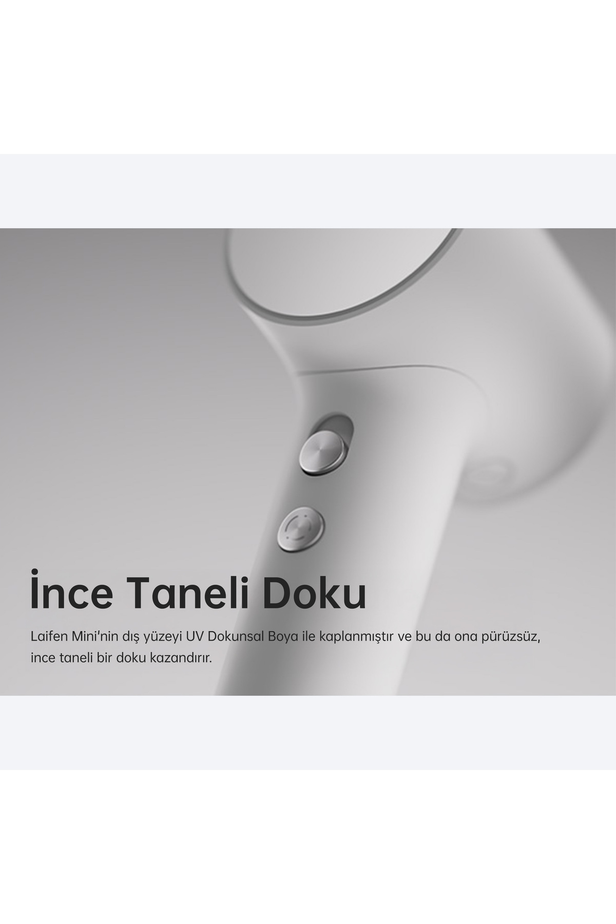Close-up of a white hairdryer with two buttons and text.