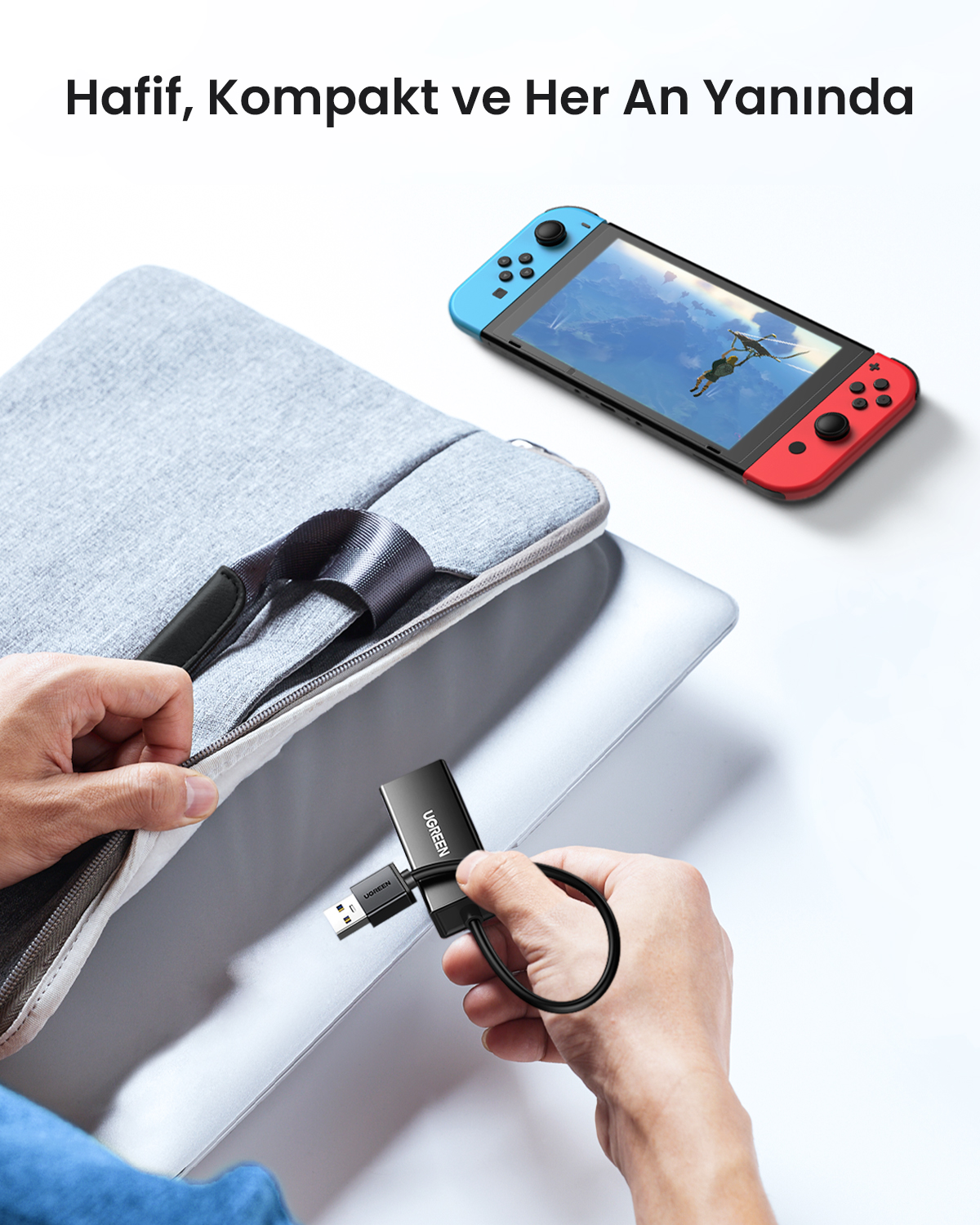 Kişi, Nintendo Switch yanında siyah UGREEN cihazını dizüstü bilgisayara bağlıyor.