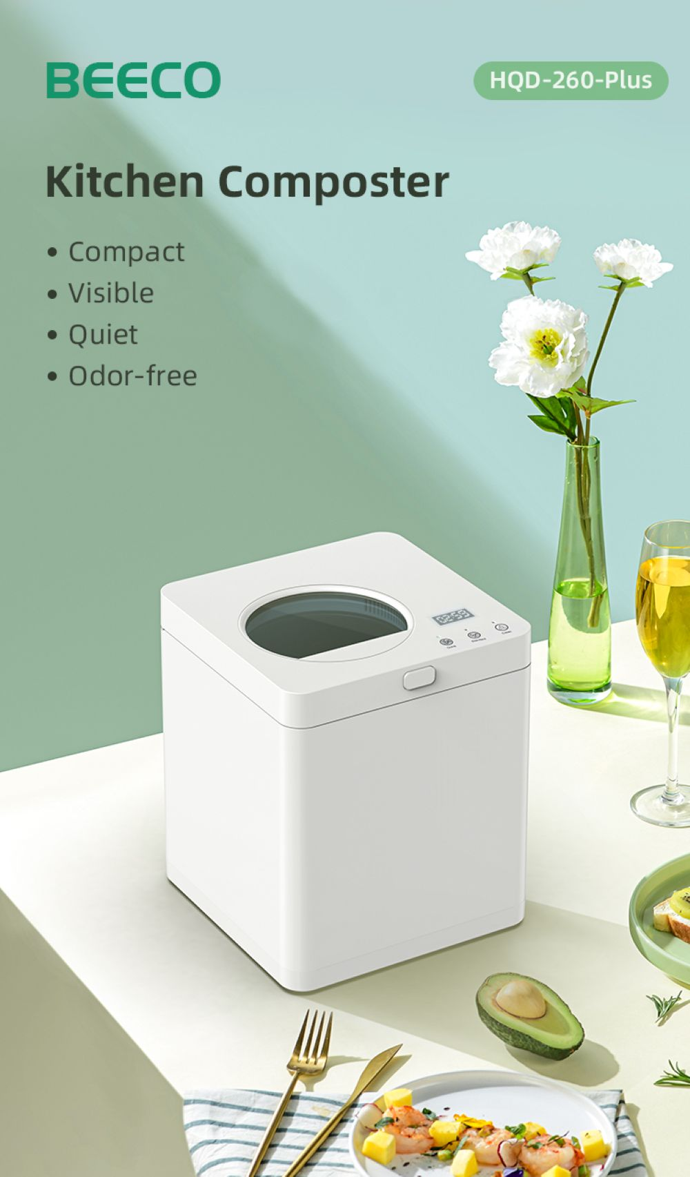 Un composter da cucina bianco con fiori e cibo su un tavolo.