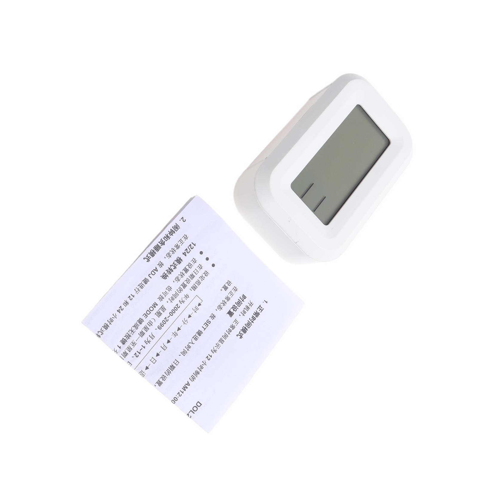 Weißer digitaler Wecker mit einem grauen LCD-Bildschirm und Bedienungsanleitung.