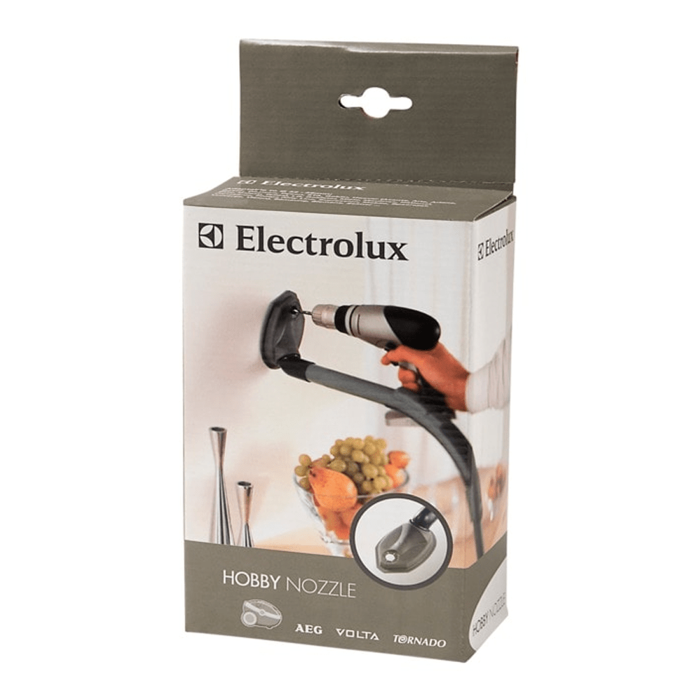 Electrolux Hobby Nozzle Verpackung mit Bohrer und Wandhalterung. Obstschale im Hintergrund.