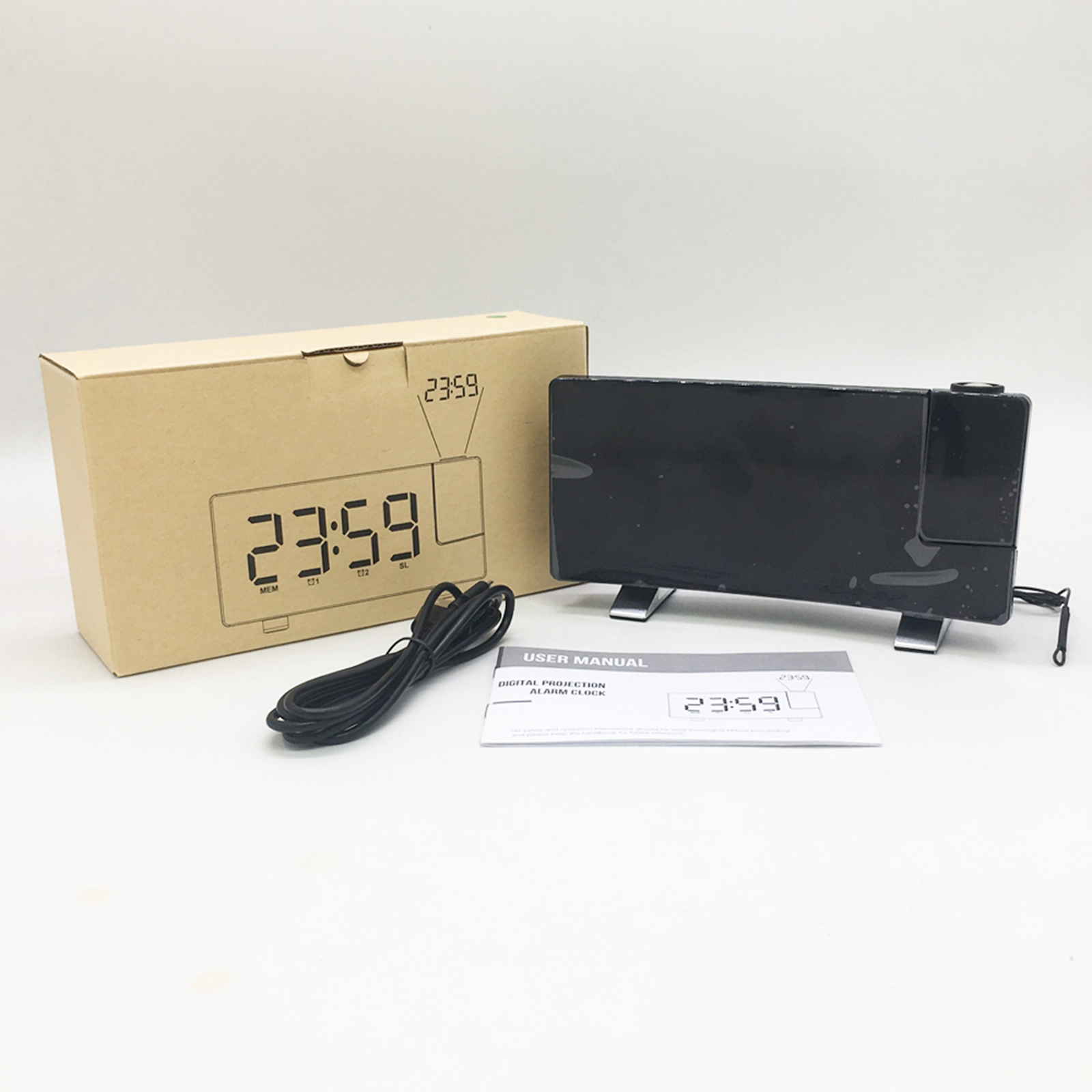 Digitalprojektionswecker mit Verpackung, Kabel und Anleitung auf weißem Hintergrund.