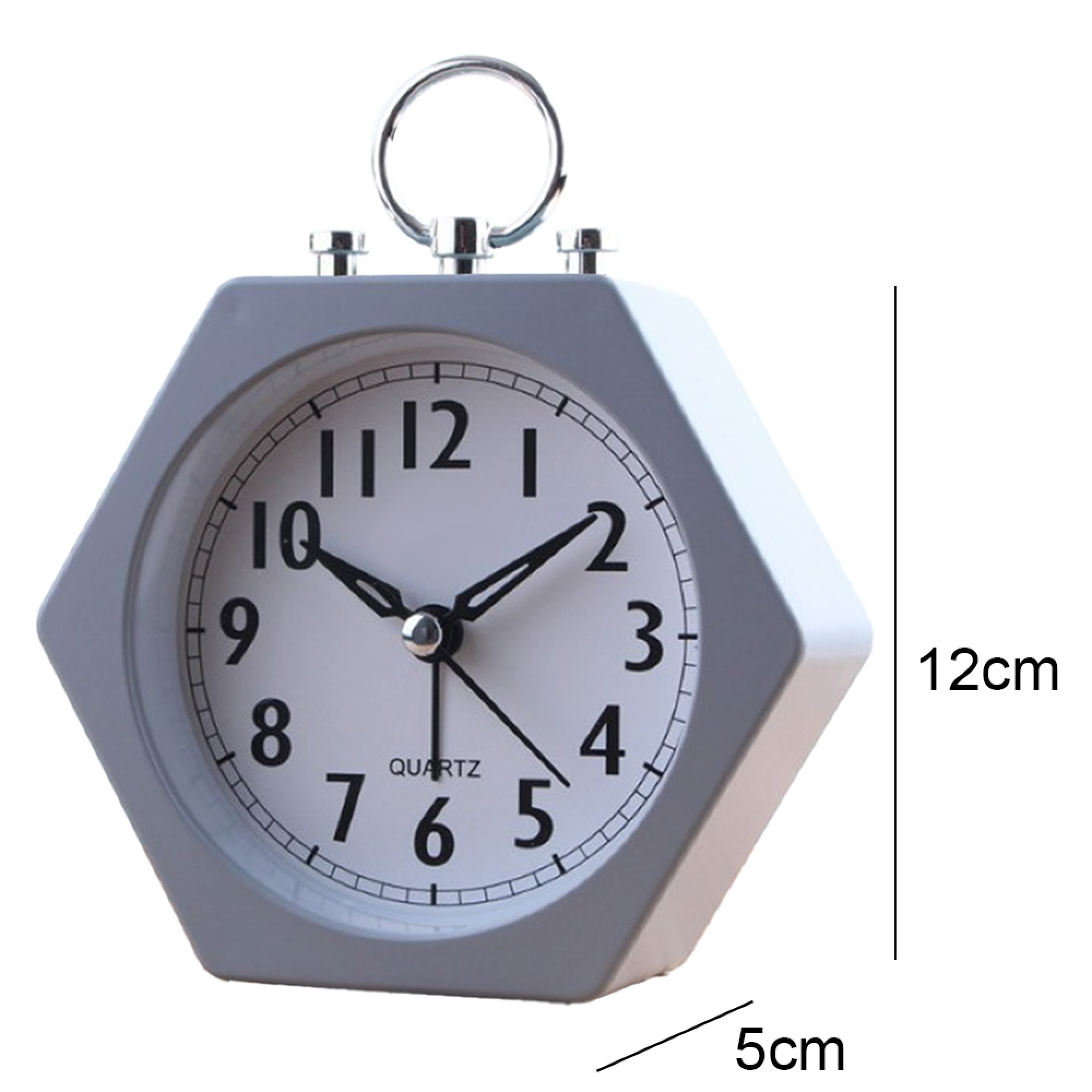 Ein sechseckiger grauer Wecker mit weißem Zifferblatt und schwarzen Zahlen. Es ist 9:50 Uhr.
