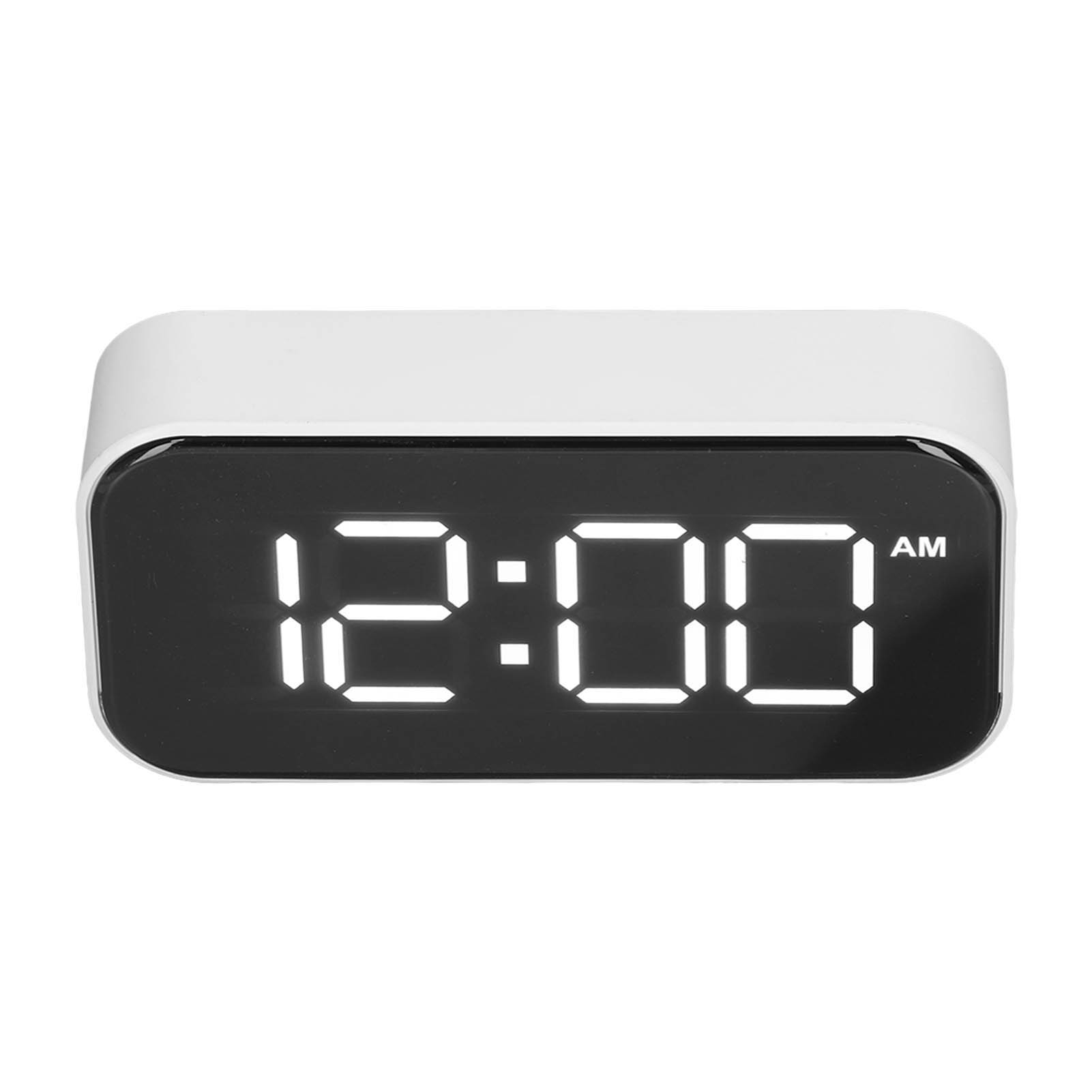 Ein weißer digitaler Wecker mit leuchtend weißen Ziffern, die 12:00 AM anzeigen.