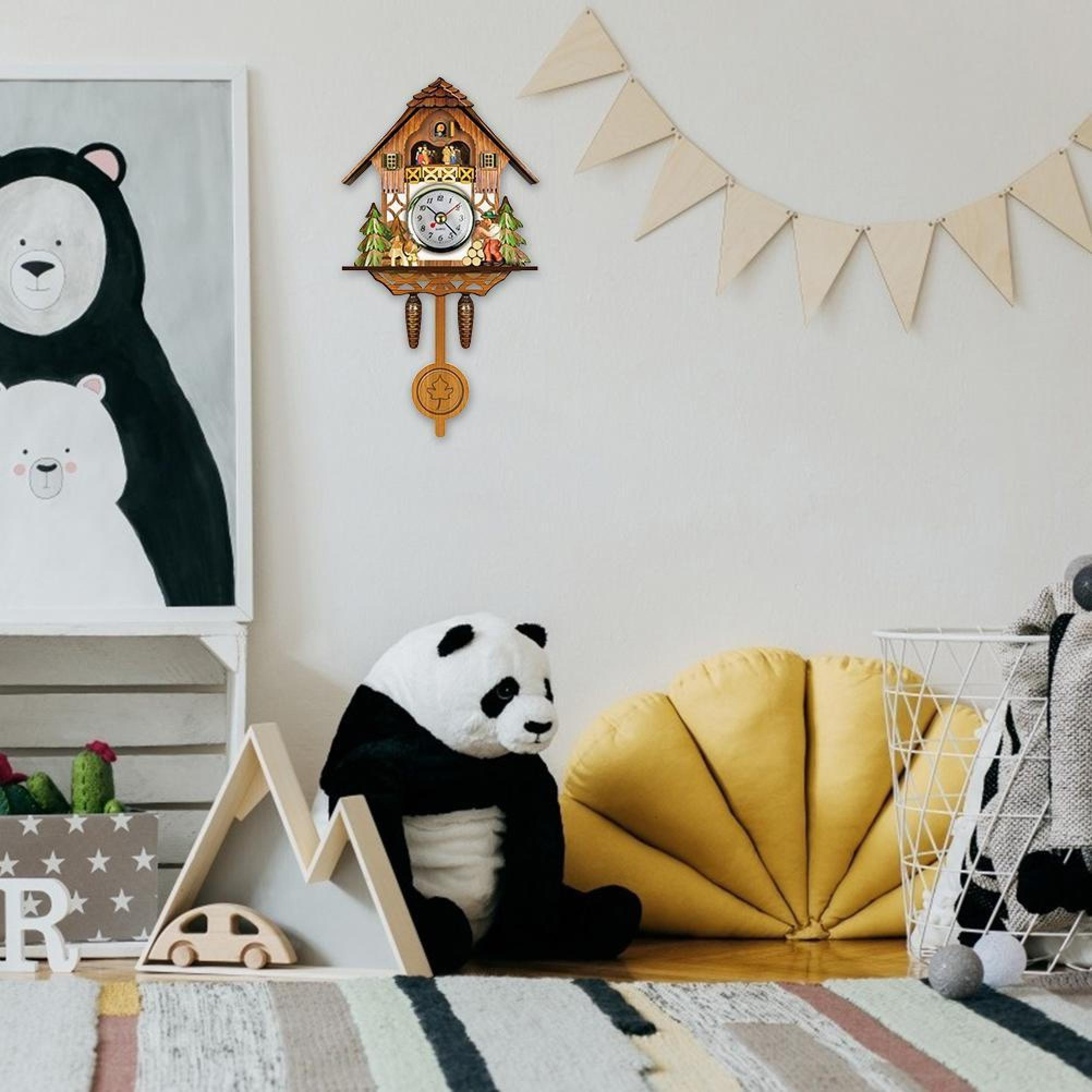 Ein Kinderzimmer mit einer Bärenzeichnung, einer Kuckucksuhr und einem Panda-Stofftier.