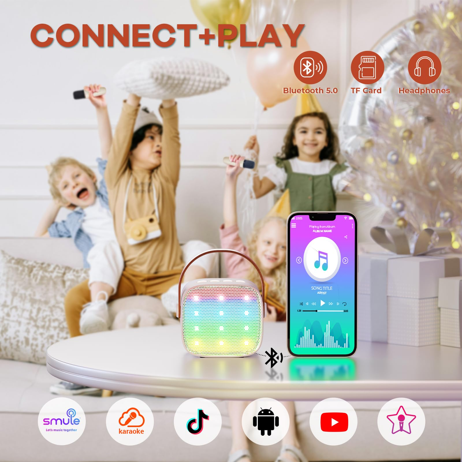 Kinder feiern mit einem bunten Lautsprecher und Handy.