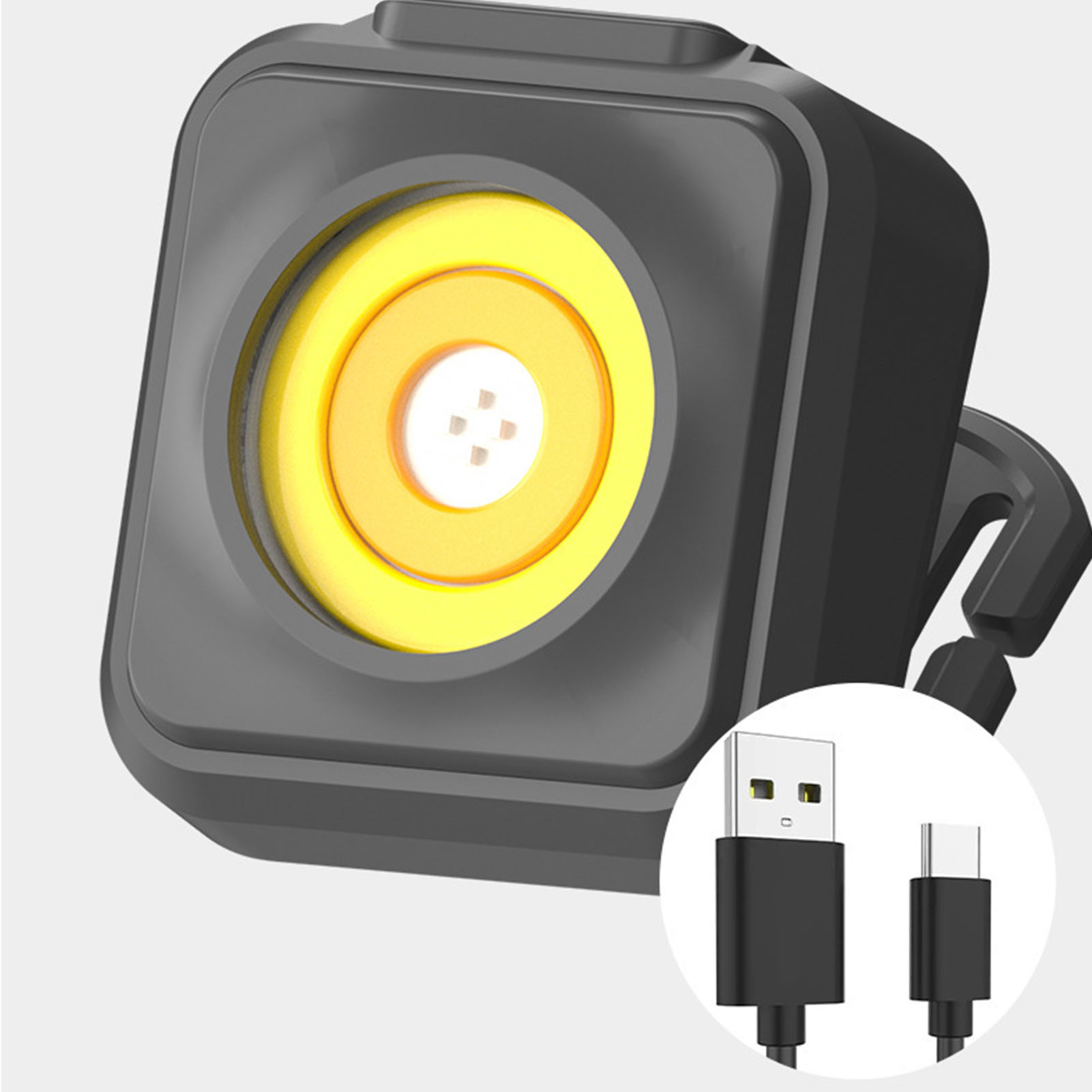 Ein schwarzer Würfellicht mit gelbem Ring und USB-Kabeln.
