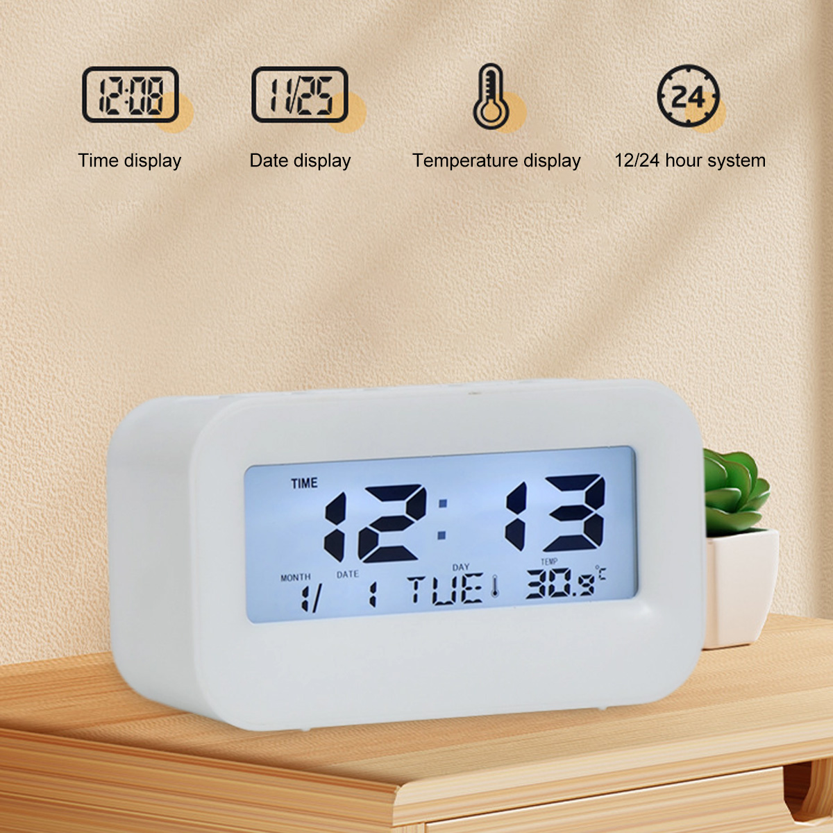Ein weißer Digitalwecker zeigt 12:13 Uhr, Dienstag, 30.9 Grad.