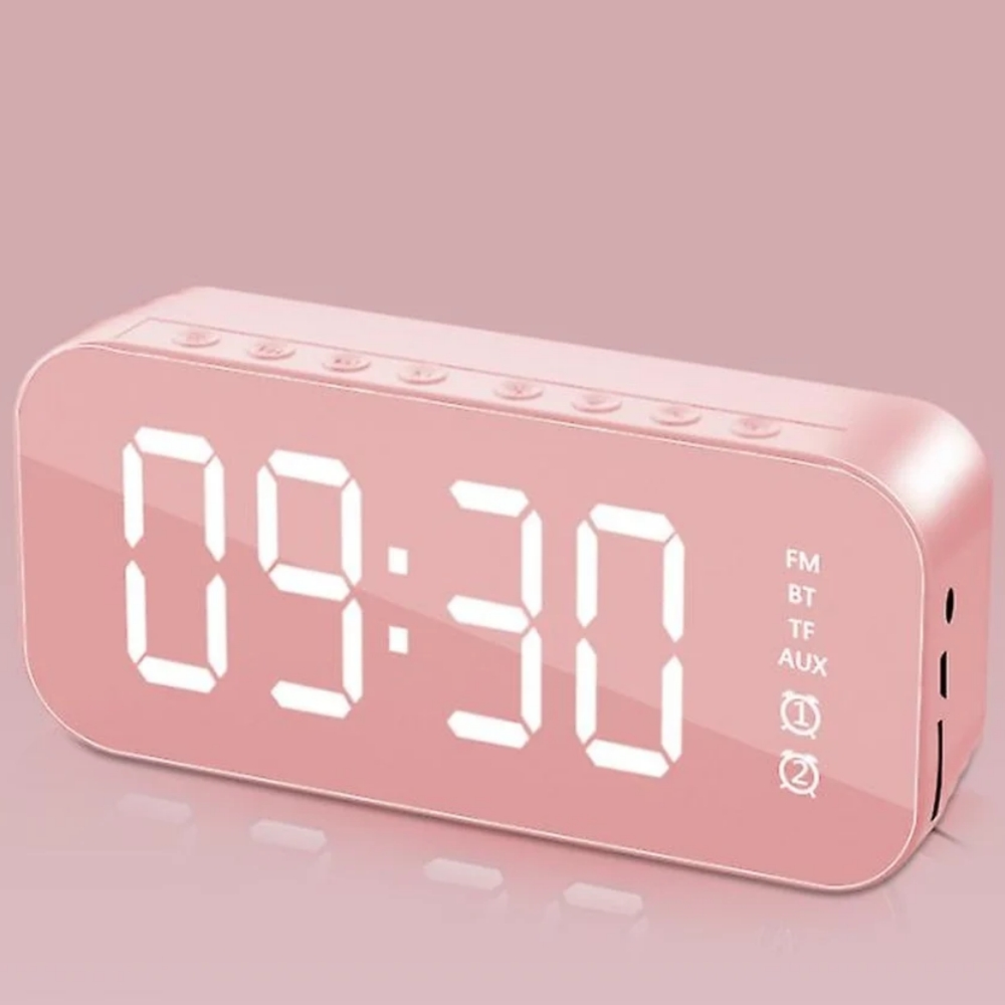 Ein pinker Digitalwecker mit verspiegeltem Display, der 09:30 anzeigt.