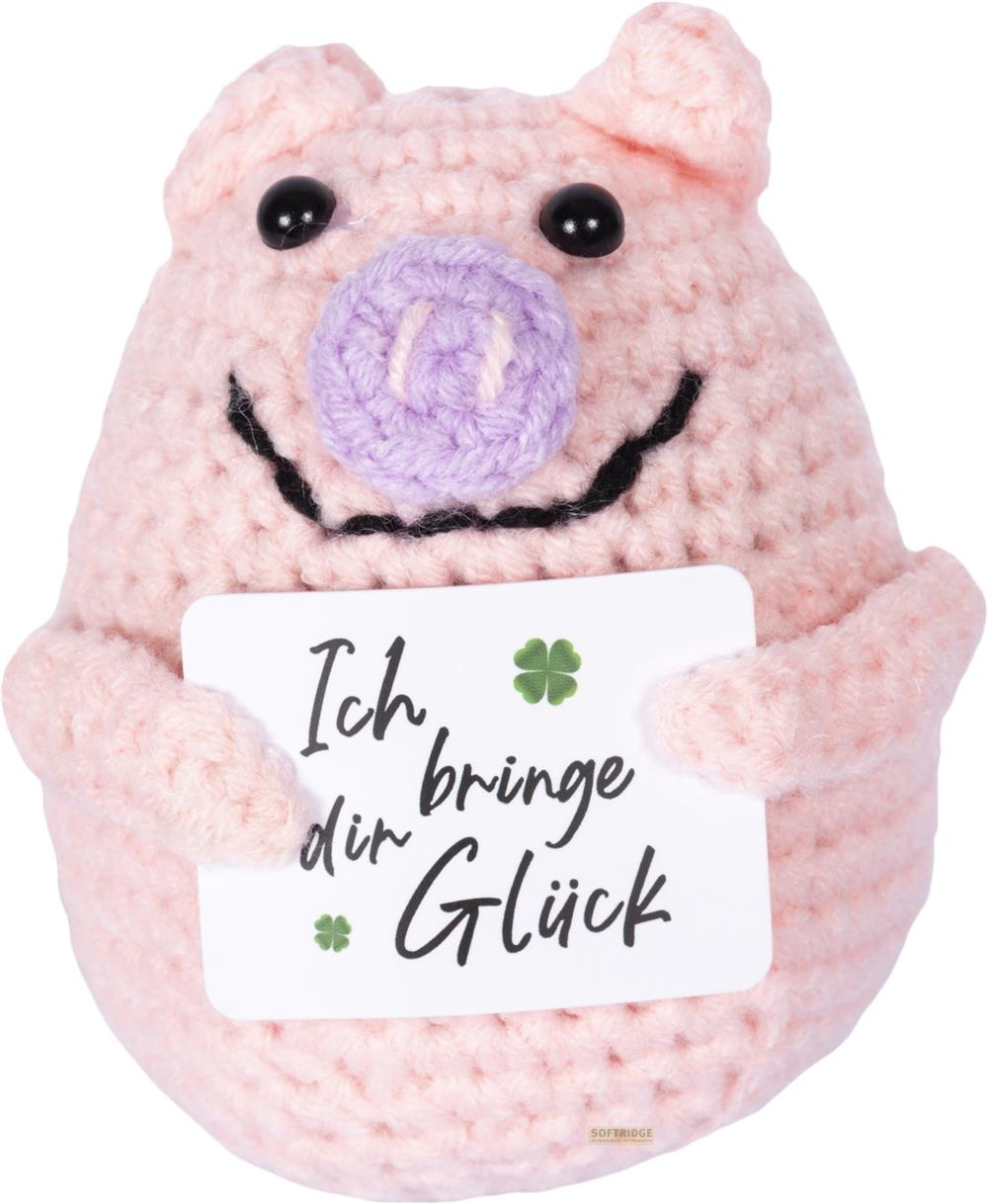 Un cochon rose au crochet tient une carte disant « Je t'apporte de la chance ».