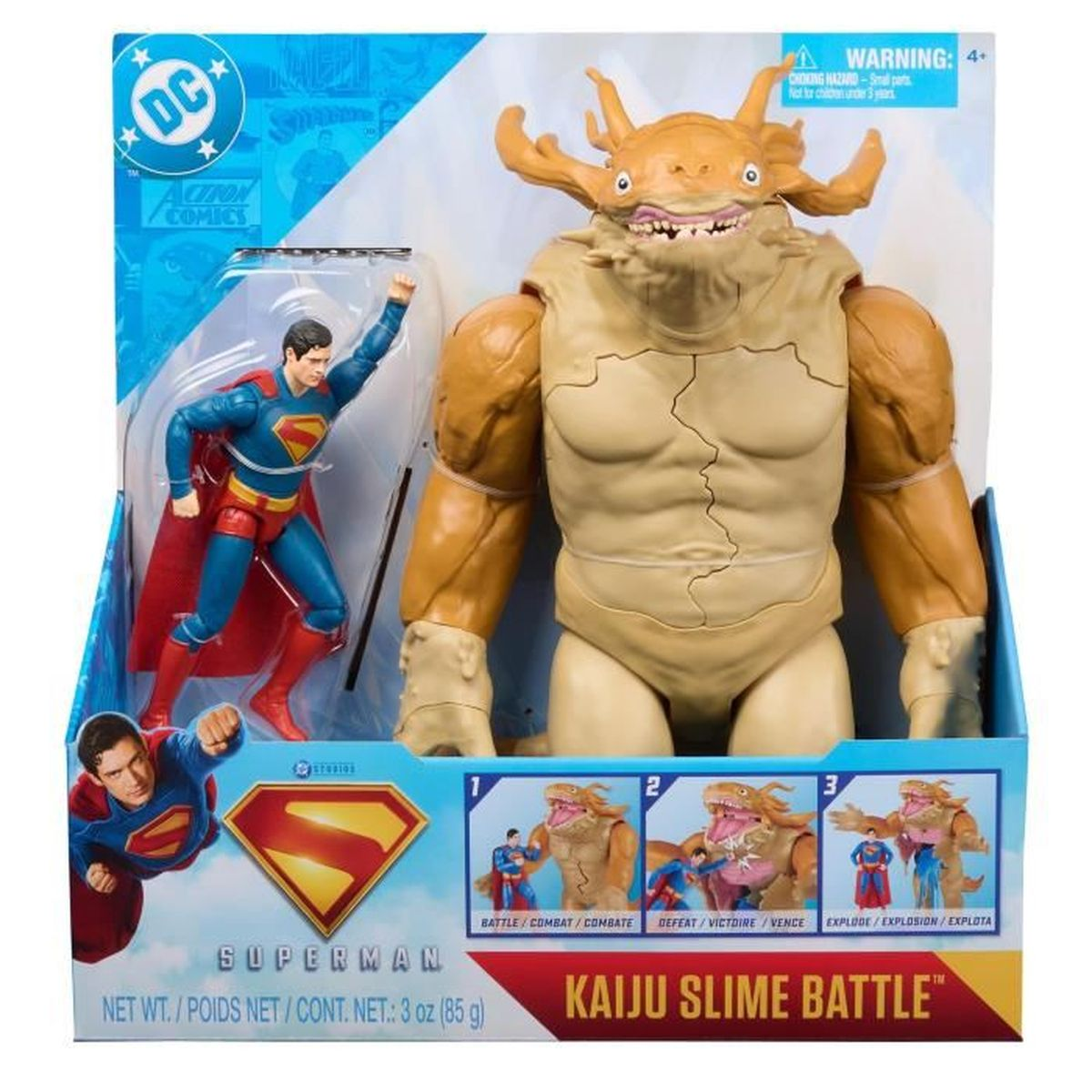 Figura de acción de Superman luchando contra un monstruo amarillo en empaque.