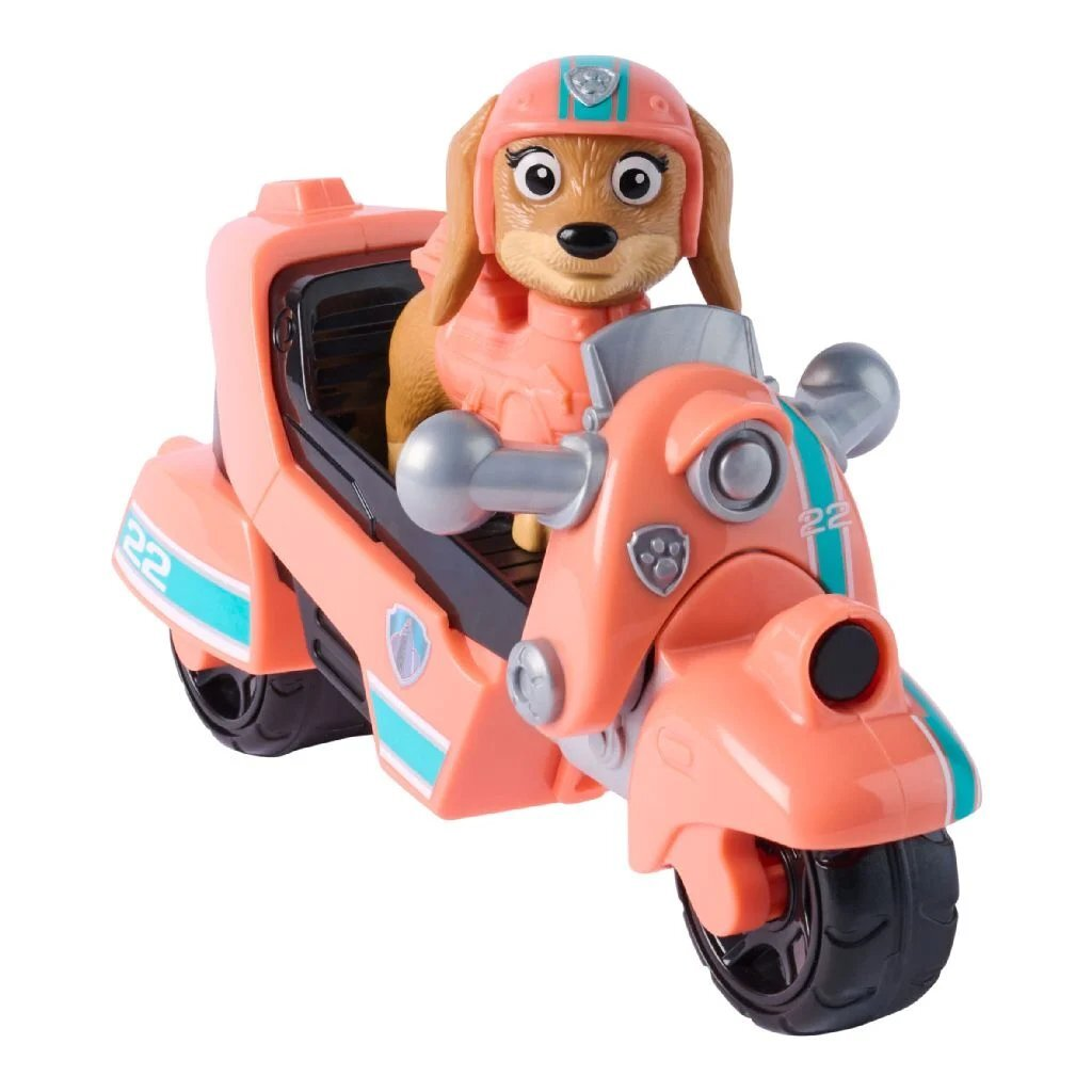 Un perro de juguete con casco rosa monta una motocicleta de juguete rosa con detalles azules.