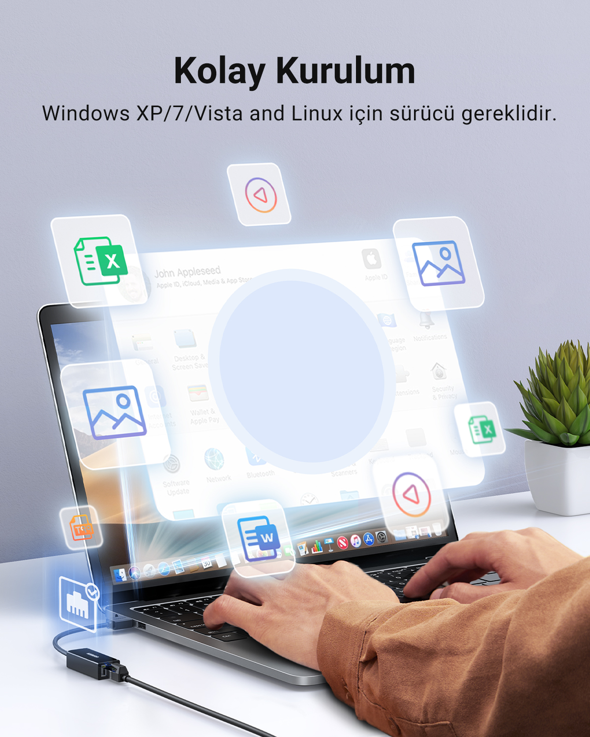 Renkli uygulama simgeleri bir dizüstü bilgisayarın üzerinde süzülürken klavyedeki eller.