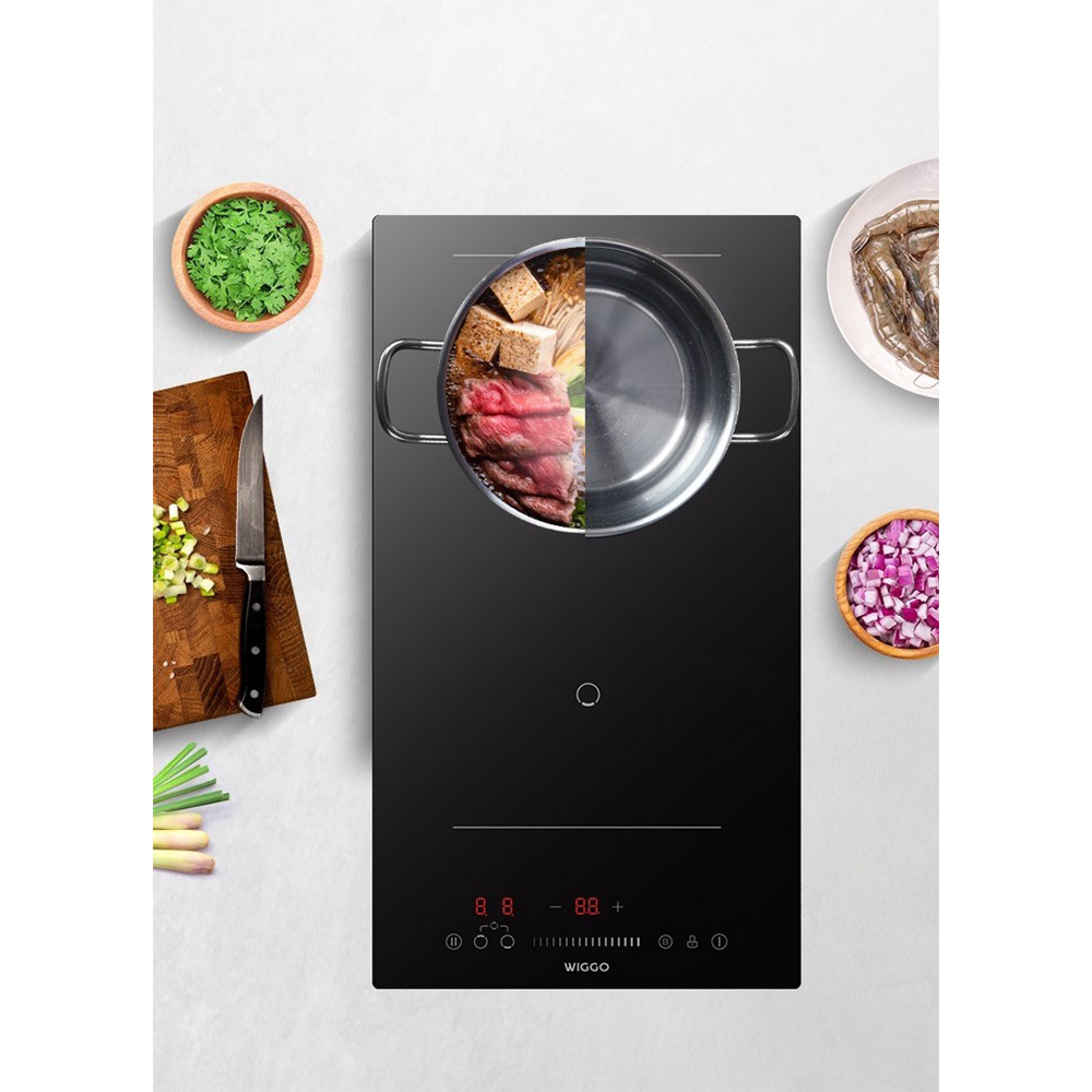 Een pan met vlees en groenten op een inductiekookplaat, met ingrediënten ernaast.