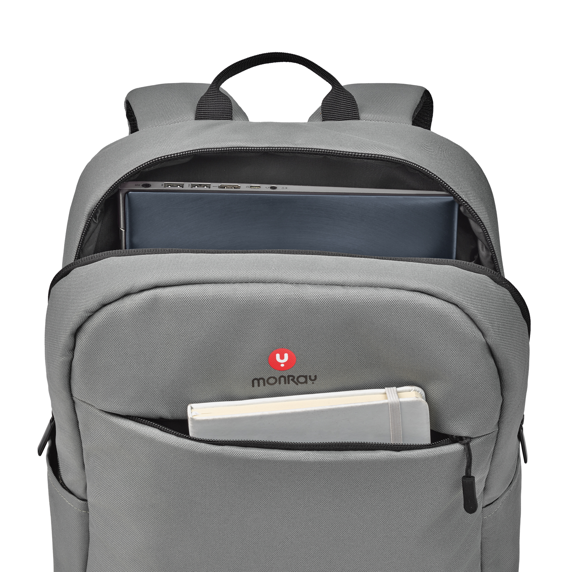 Zaino grigio con scomparto principale aperto, laptop e taccuino visibili.