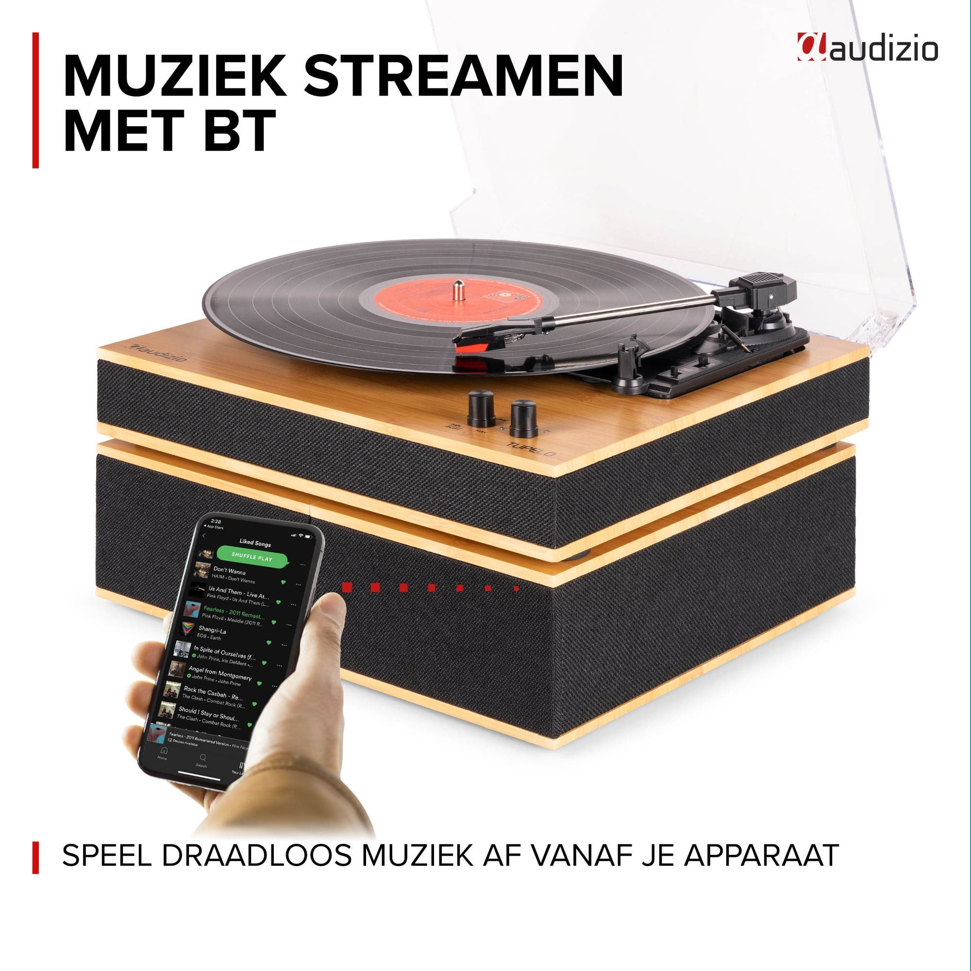 Record player with vinyl record and smartphone controlling music.