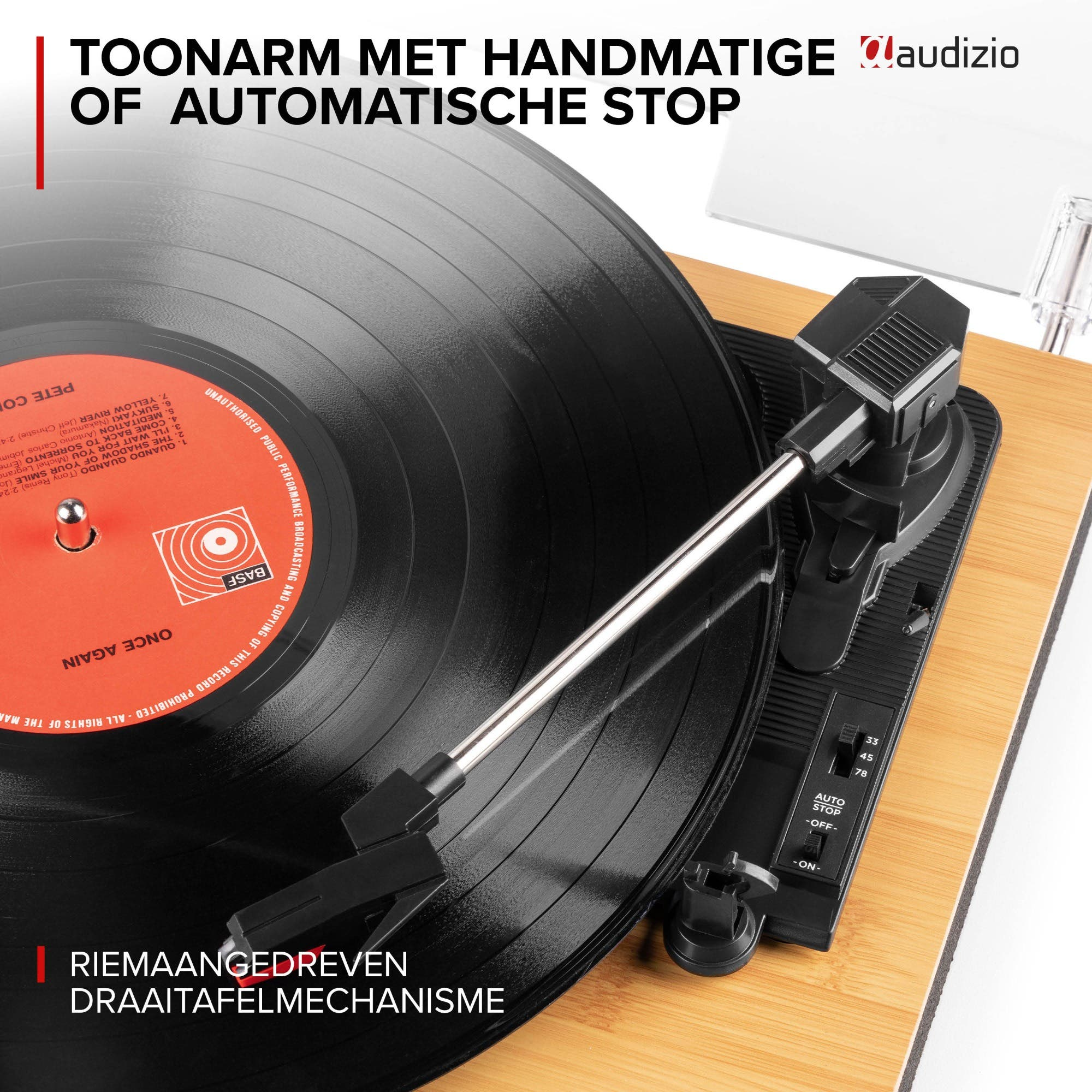 Turntable with tonearm and auto-stop function on a wooden base.