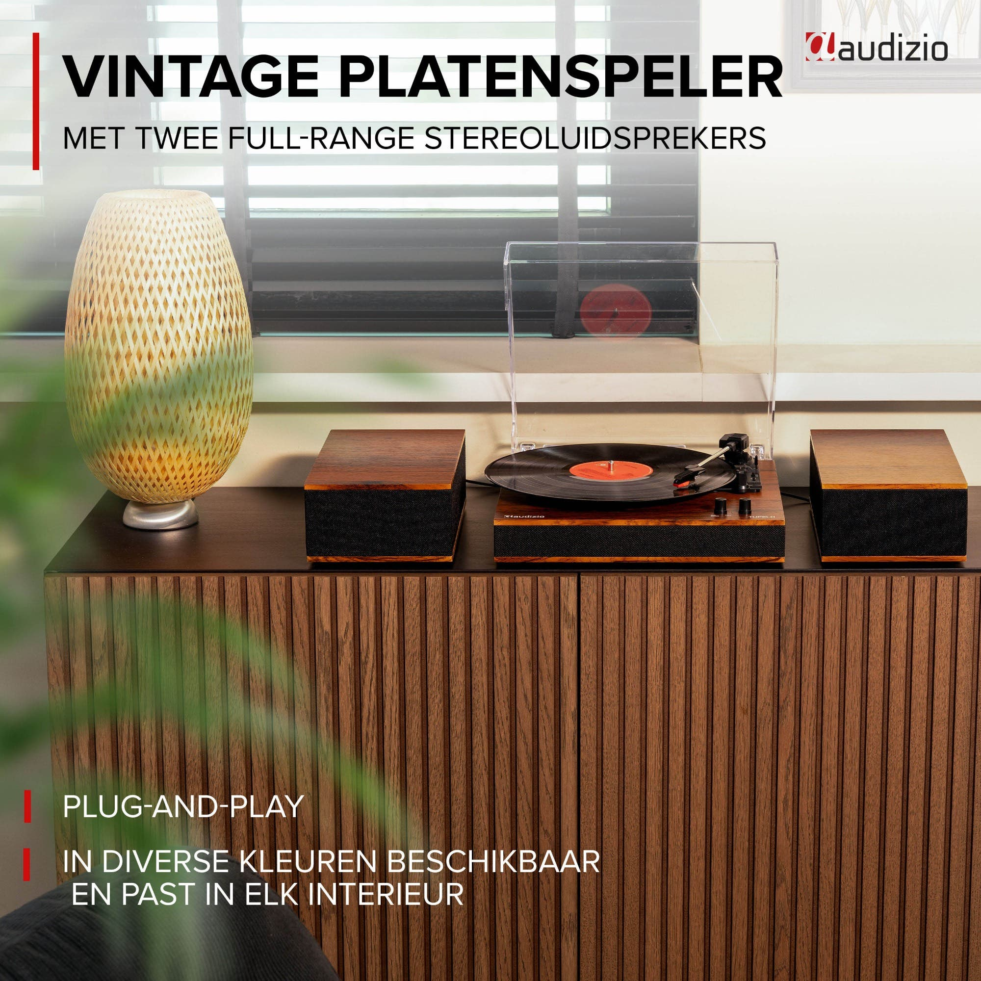 A vintage record player with two speakers on a wooden cabinet.