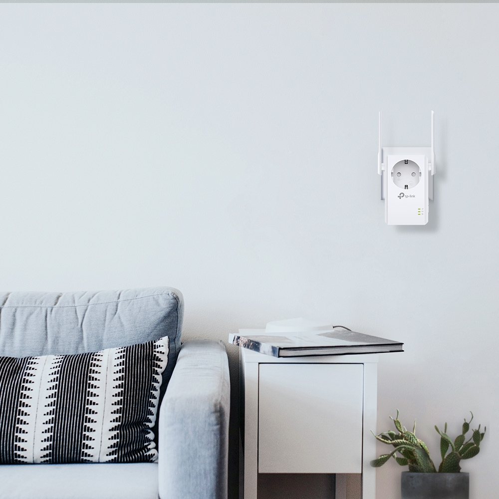 A white Wi-Fi extender with antennas plugs into an outlet on a white wall.
