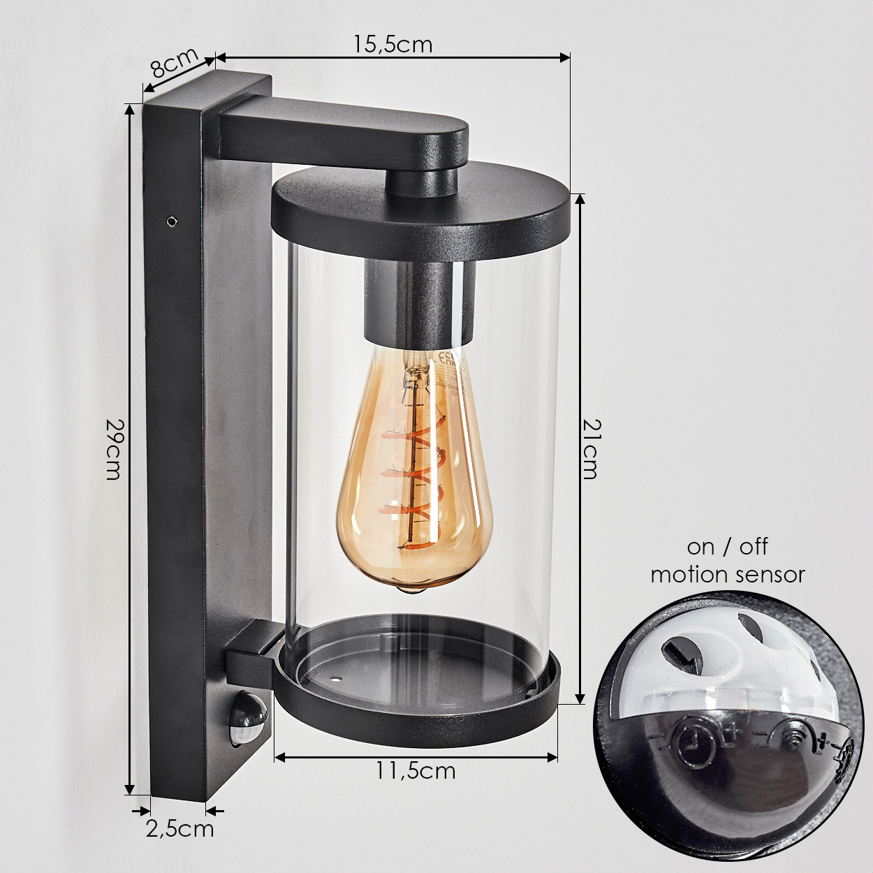 Schwarze Wandleuchte mit Glaszylinder, sichtbarer Glühbirne und Bewegungssensor.