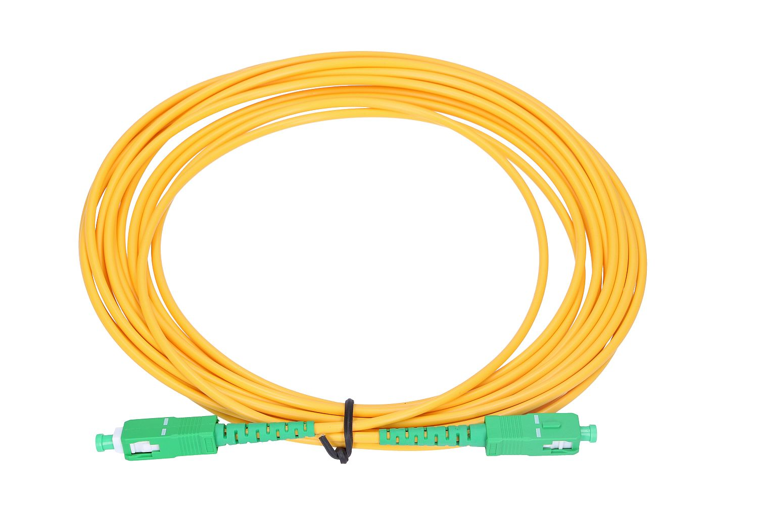 Żółty kabel światłowodowy z zielonymi złączami jest zwinięty.