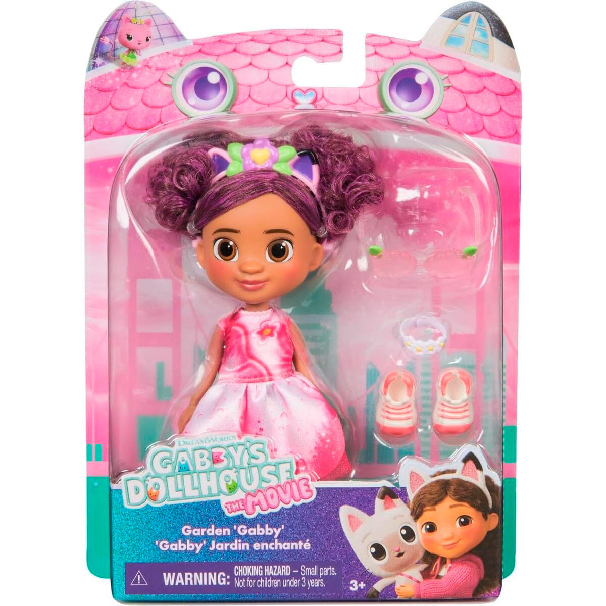 Muñeca Gabby con pelo morado, vestido rosa y accesorios en caja.
