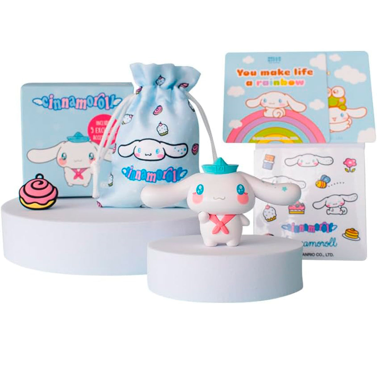 Figura y accesorios de Cinnamoroll sobre pedestales blancos ante fondo blanco.