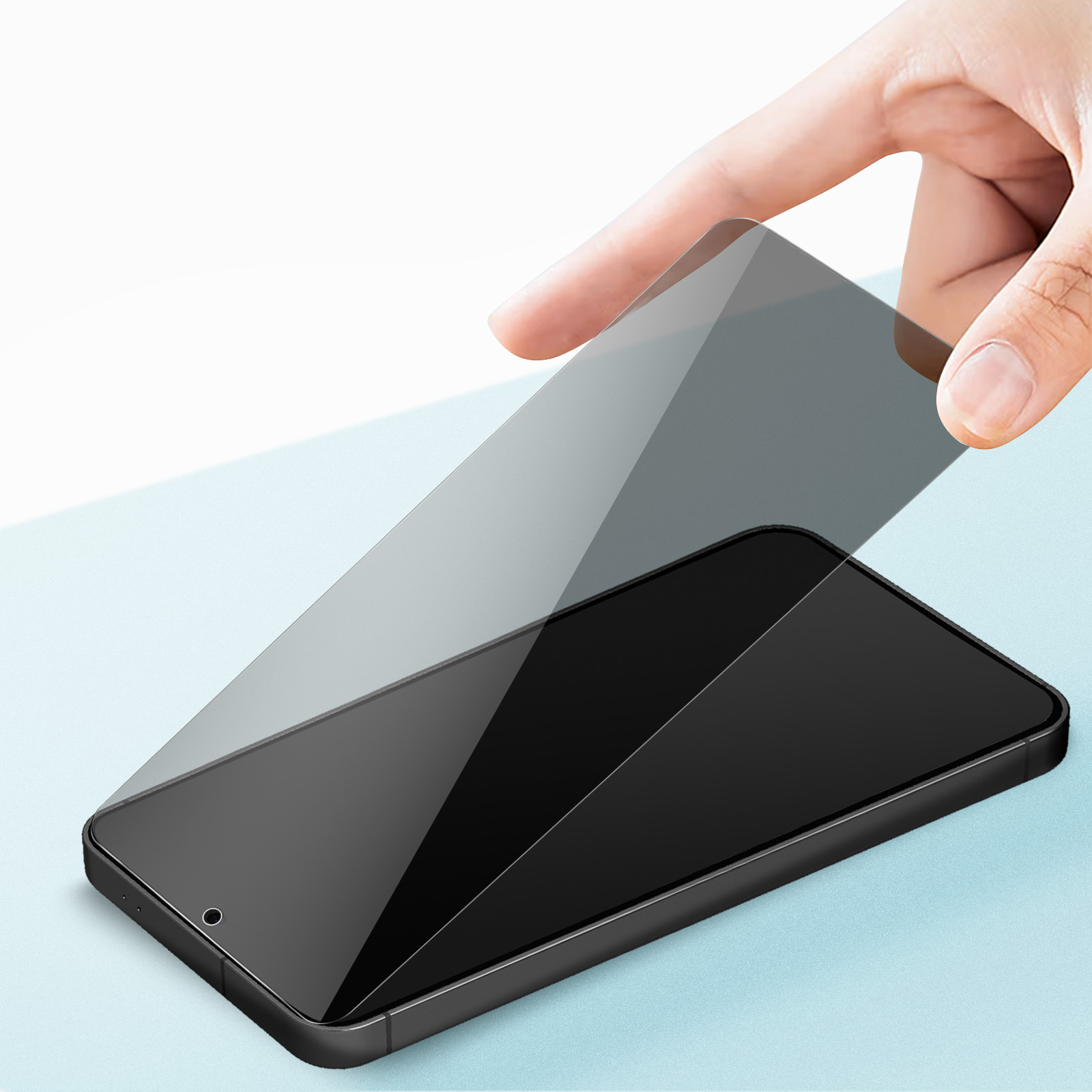 Una mano posiziona una protezione per lo schermo su uno smartphone nero.