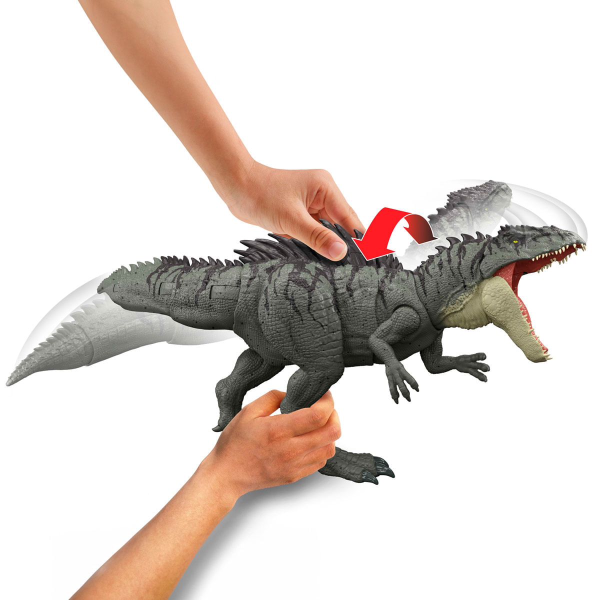 Juguete de dinosaurio gris con boca abierta, sostenido por manos, con flecha.