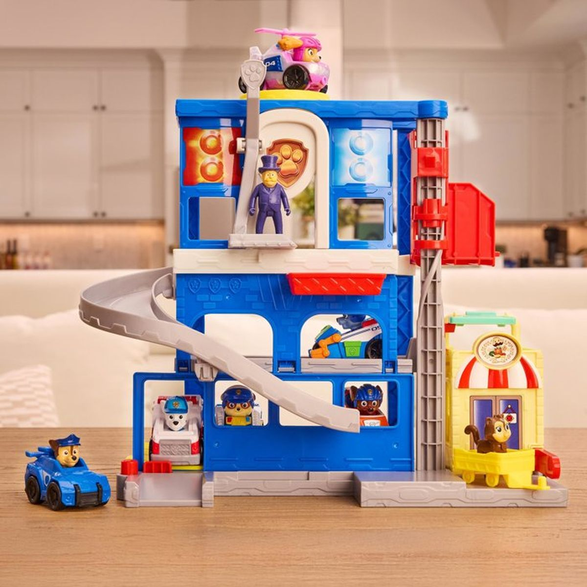 Un set de juego de Paw Patrol con figuras, vehículos y un tobogán.
