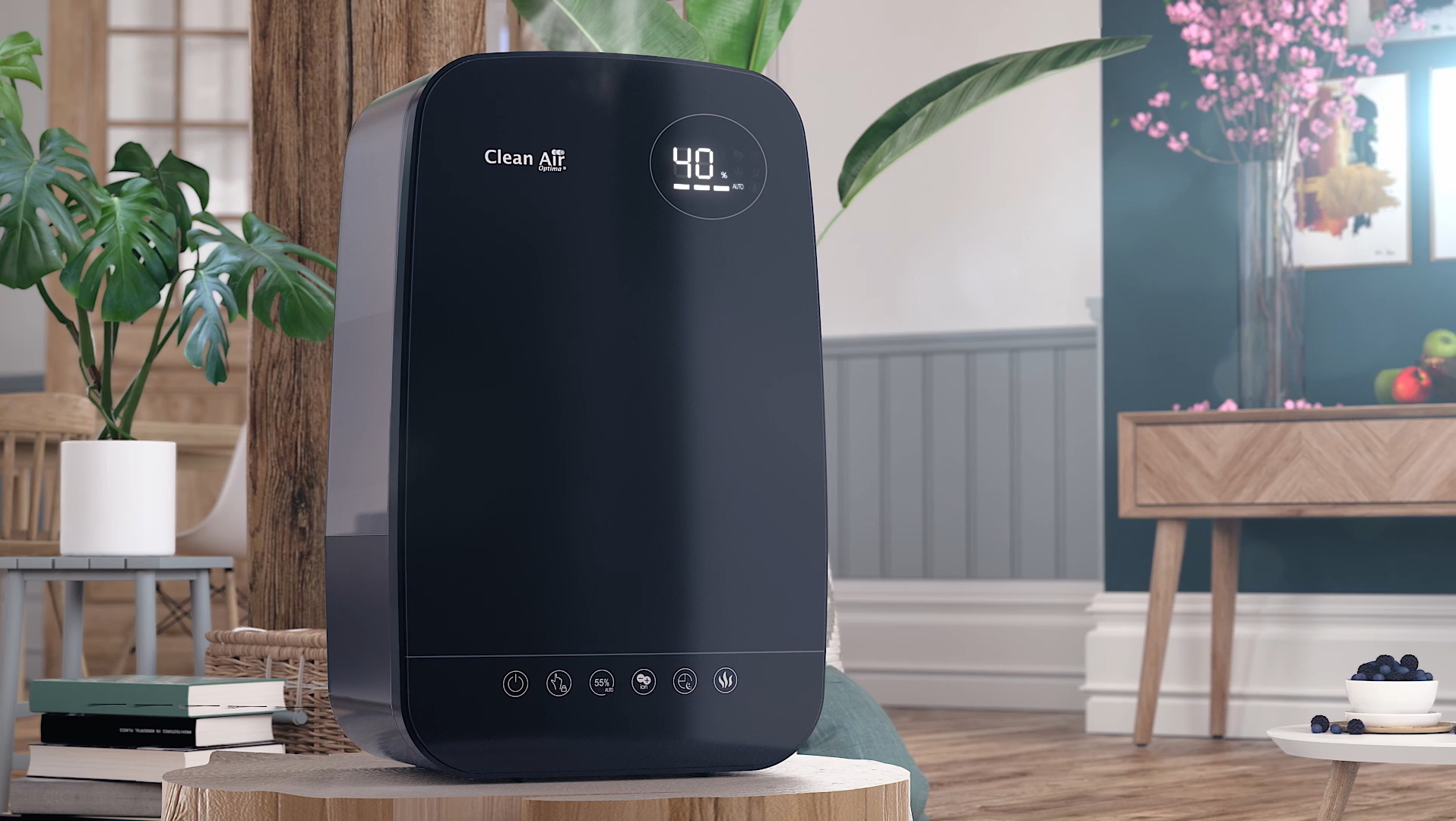 A dark air purifier with a digital display sits on a wooden stand, near plants and furniture.