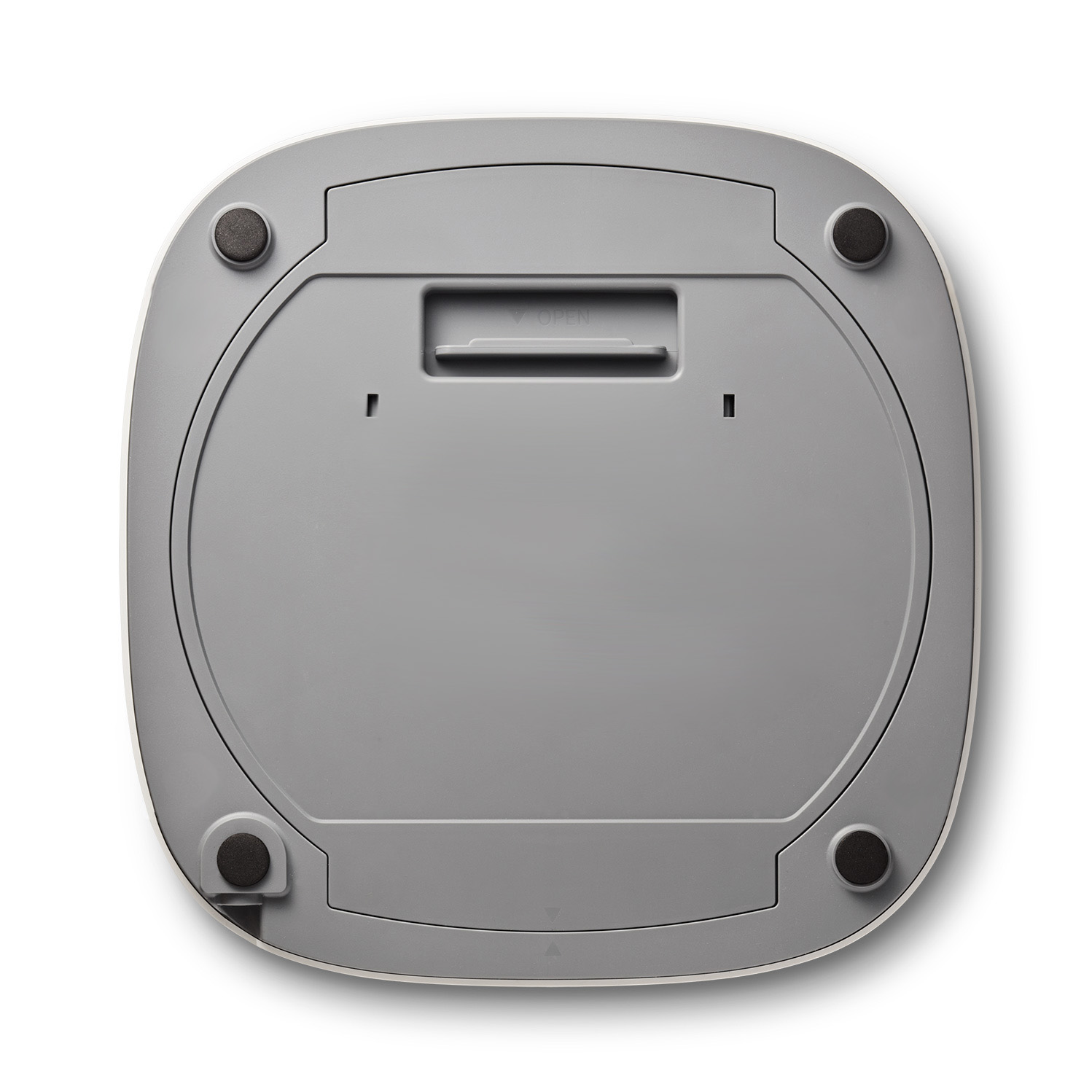 Underside of a white device with a gray top plate, four rubber feet, and an opening.