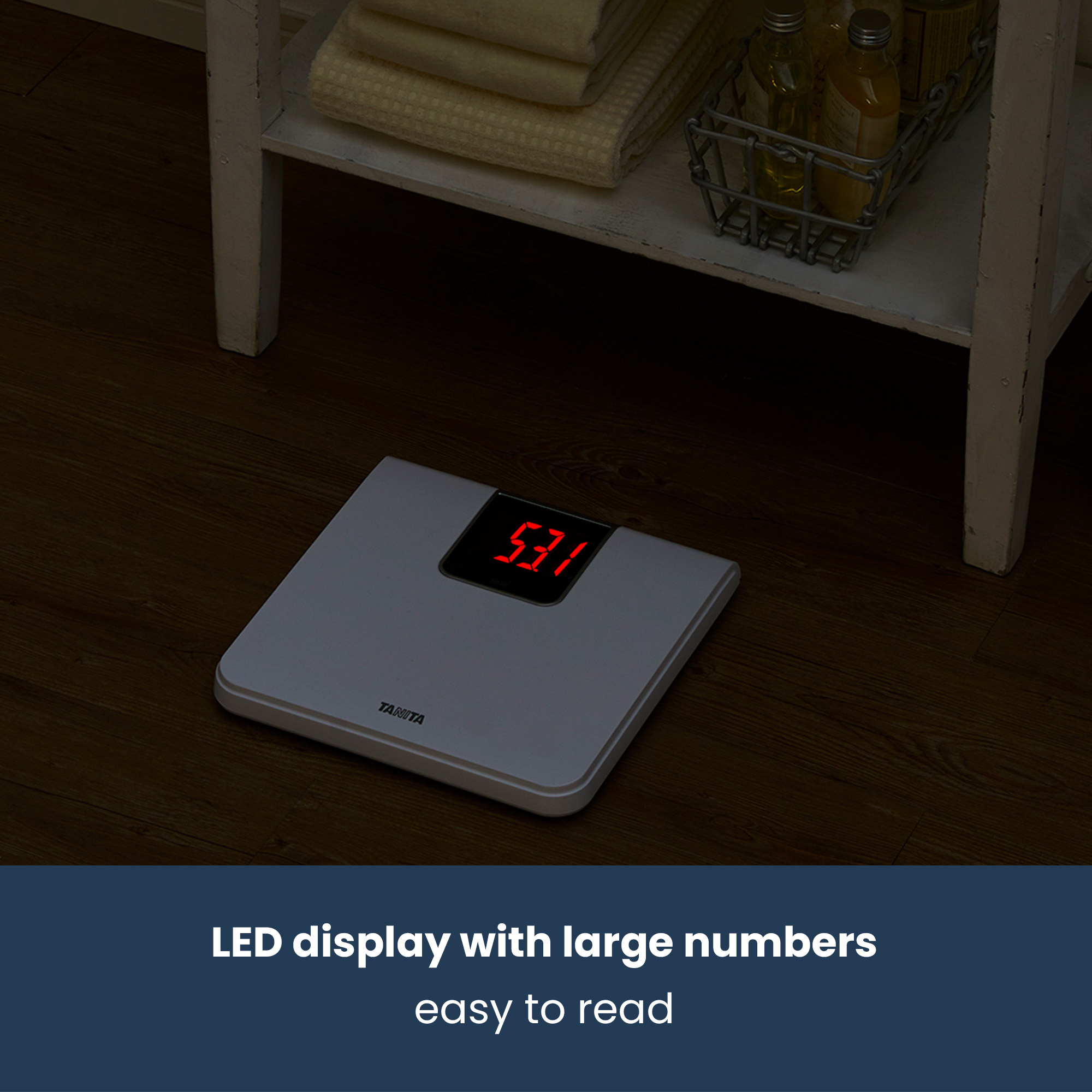 White scale with red LED display shows 53.1 on a wooden floor.