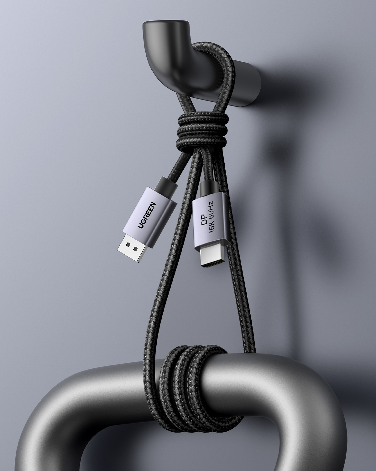 Cavo intrecciato nero con connettori USB-C e DisplayPort appeso a barre metalliche.