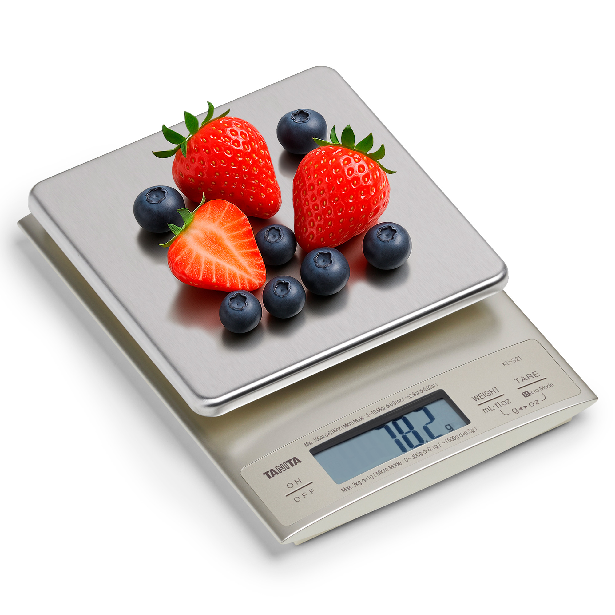 A digital kitchen scale with blueberries and strawberries.