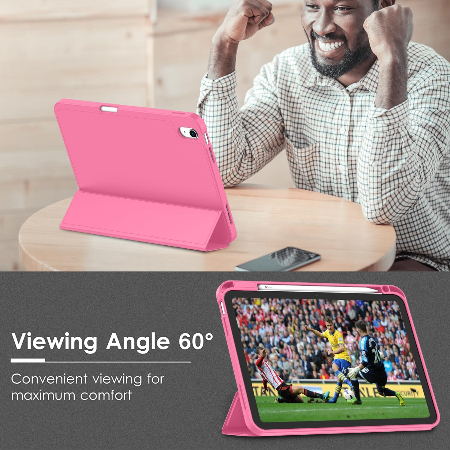 Ein Mann lacht, während ein rosa Tablet mit Fußballspiel angezeigt wird.