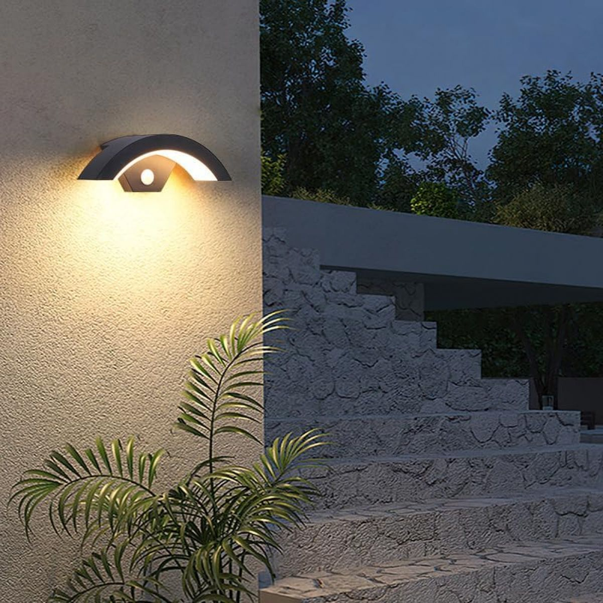 Moderne Wandleuchte beleuchtet eine Steinwand und eine Außentreppe im Dunkeln.