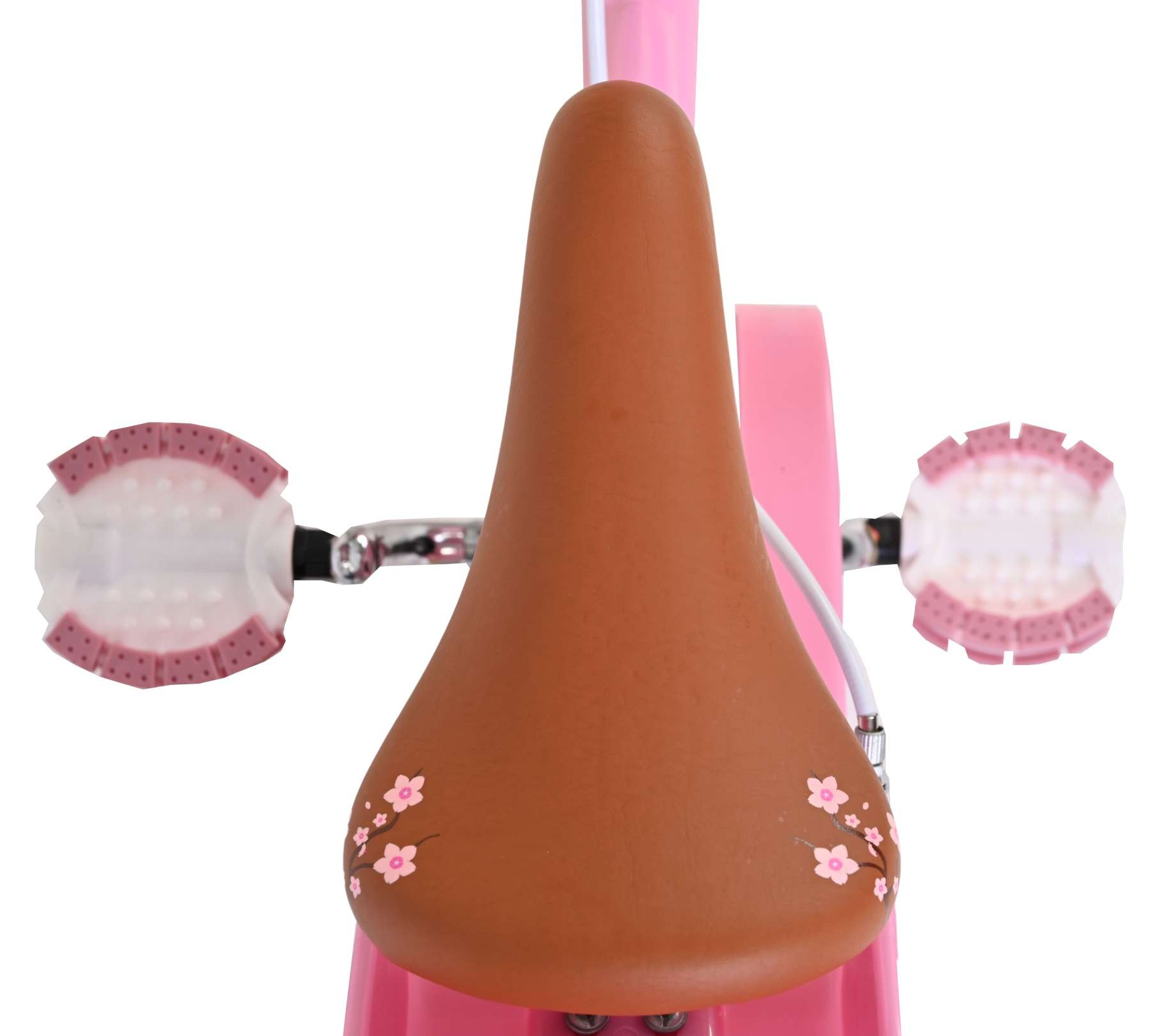 Ein brauner Fahrradsattel mit rosa Blumenmuster, auf einem pinken Kinderfahrrad.