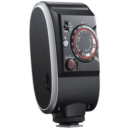 Unità flash fotocamera nera con ghiera e interruttori, pannello laterale testurizzato.