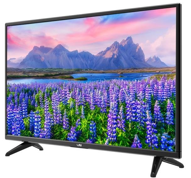 Czarny telewizor wyświetla krajobraz gór, jeziora i fioletowych kwiatów.