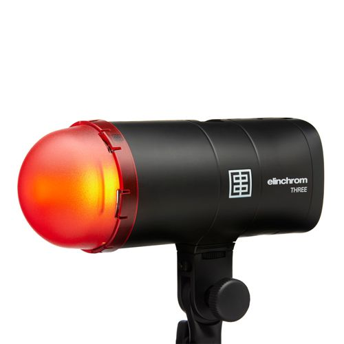 Une tête de flash Elinchrom noire avec un dôme rouge et un logo.