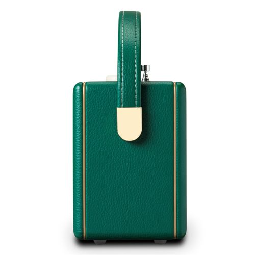 Haut-parleur portable vert avec garniture dorée et poignée.