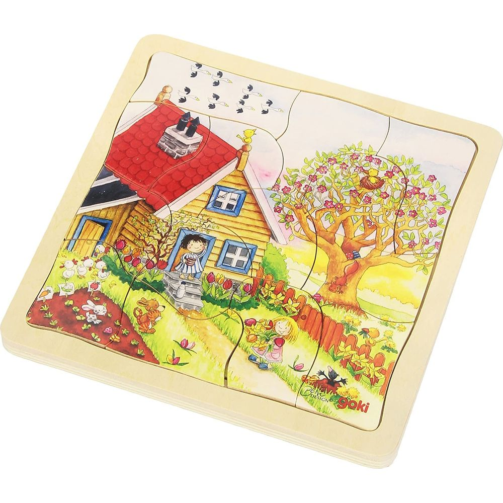Rompecabezas de madera con casa, jardín, niños, animales y pájaros.