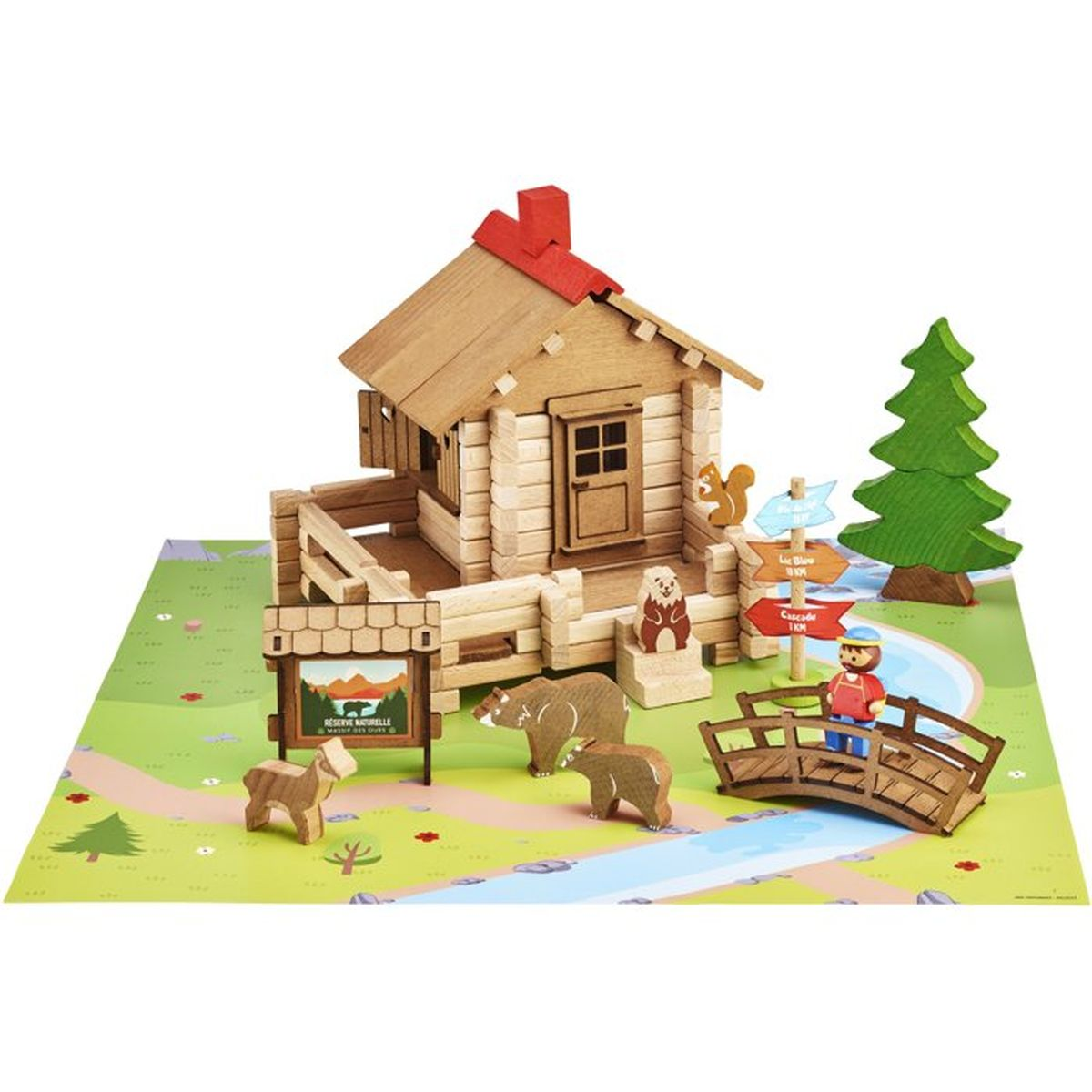 Set gioco capanna in legno con animali, cartelli, albero, ponte e figura su tappeto.