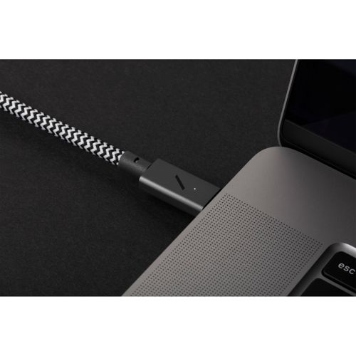 Una spina del cavo bianca e nera è inserita in un laptop.