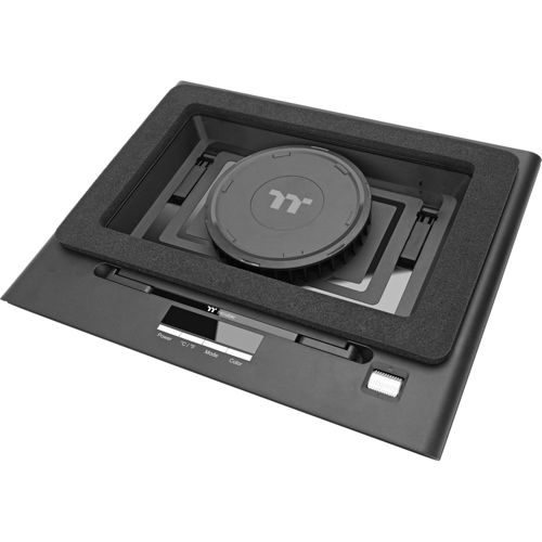Un dispositivo rectangular negro con una tapa redonda y negra en el centro.